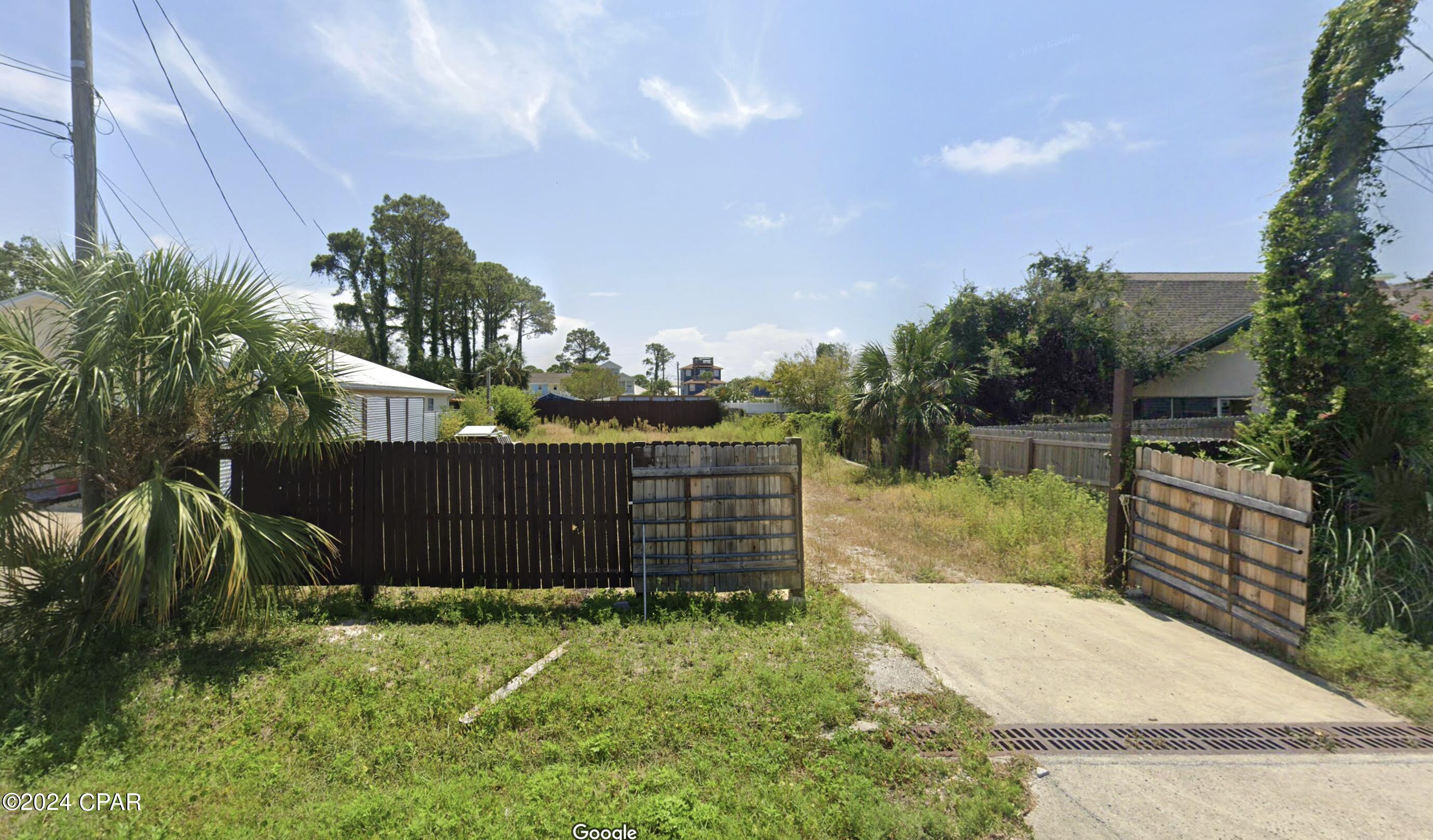 Very nice cleared and fenced buildable lot close to the beach and the bay! Lot is ready for you to start building your home right away with water, sewer and electric already onsite. Concrete drainage driveway already in place is a huge added bonus! Take a look at this lot and imagine the beach home you could build!
