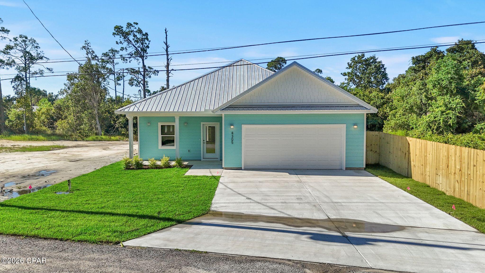 Brand-new coastal-style home in the desirable Bay Point area with NO HOA! Located in the established Magnolia Beach neighborhood, this thoughtfully designed single-level residence offers three bedrooms, two bathrooms, approximately 1,650 square feet of heated and cooled living area, and an attached two-car garage. Interior features include luxury vinyl plank flooring, stone countertops, stainless-steel appliances, contemporary cabinetry, a pantry, a spacious primary suite with walk-in closet, and bright, modern finishes throughout. The home also features a finished attic/storage area with drywall and flooring that benefits from partial conditioning through the home's HVAC system, providing unusually comfortable and versatile additional storage space. Energy- and storm-conscious construction includes spray foam insulation and hurricane-rated windows and doors, and the home is backed by a builder warranty. The exterior features coastal-blue siding, a white metal roof, covered front and rear porches, and a landscaped, fenced backyard with an irrigation system. Enjoy brand-new construction without HOA dues or restrictions in the sought-after Bay Point area, convenient to Bay Point Marina, golf, dining, shopping, St. Andrews State Park, the Navy Base, and the beaches of Panama City Beach. Certificate of Occupancy pending completion of final municipal water and sewer connection.