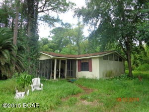 200X150 lot with double wide MH two blocks of Hwy 98 with walking distance to the water. This mobile home features a split bedroom floor plan, large combined living room & dining area with a fireplace & vaulted ceiling. You'll have a 10'X16.9 screened front porch and a 12.5X14.2 deck in the rear of the home. Bring your working clothes & tools as the mobile home is in poor condition & priced as such. Located in Flood Zone AE.  Property is being sold ''AS IS'' with no warranties. All sizes are approximate & should be verified