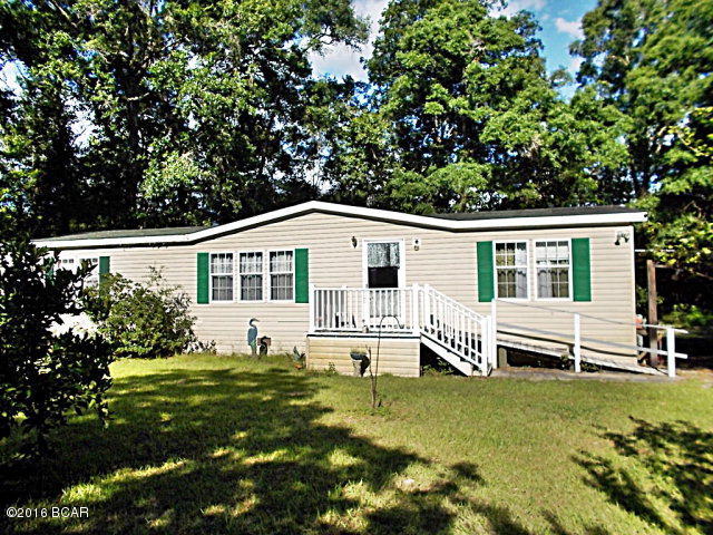Chipola River FISHERMAN'S PARADISE This home is just 5 minutes from downtown Wewa with 150 ft on the Chipola River very nice 3/2 mobile home with 4 outbuilding, carport, screened back porch fenced back yard,board walkway to the floating dock on the Chipola River, this place is high and dry not in a flood zone, a beautiful spot for retirement or a weekend home. Call agent today to view this home, very private but just minutes from town.