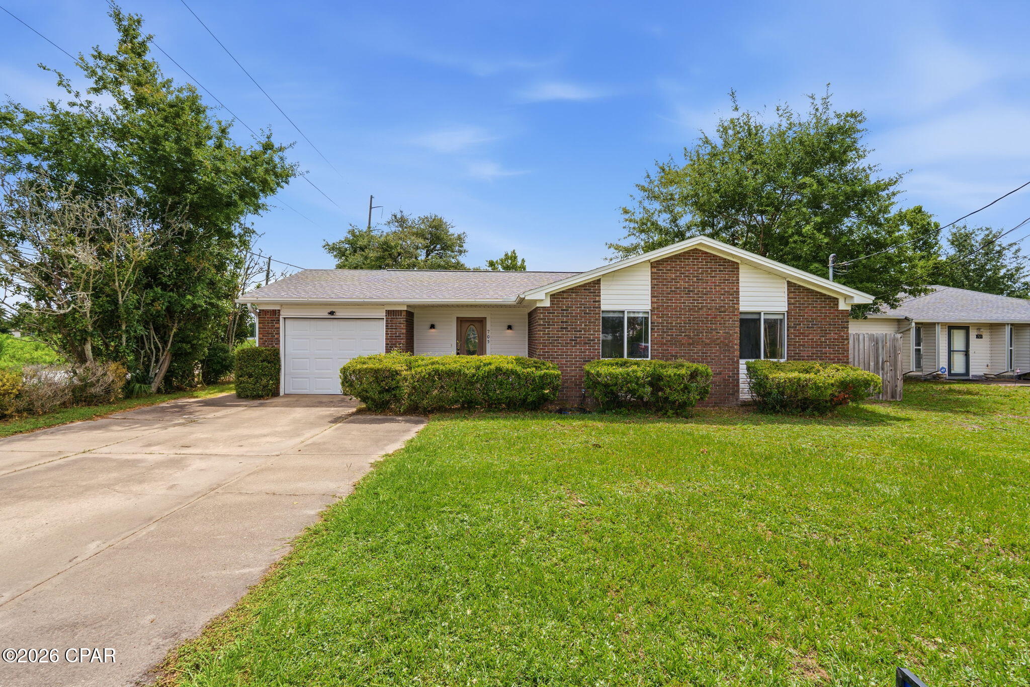 Investors, there is a current lease that must be honored through July 31, 2027.  Thoughtfully renovated in 2024, this 3-bedroom, 2-bath home offers modern updates and a convenient location. The updated kitchen features new cabinetry, quartz countertops, and stainless steel appliances. Ceramic tile flooring extends throughout the main living areas, while the bedrooms feature durable luxury vinyl plank flooring.  Natural gas services the heating system and water heater. The spacious primary suite includes a custom walk-in tiled shower in the bath.  A separate den provides additional living space and overlooks the large, privacy-fenced backyard. There is plenty of room for a pool, pickleball court, play area, etc.  Additional features include an attached one-car garage and a double gate with access from Lake Avenue, offering added convenience for boat or trailer storage.  The roof was replaced in December, 2018.  Ideally located just one block from Tyndall Parkway, this home provides easy access to shopping, dining, and everyday amenities.