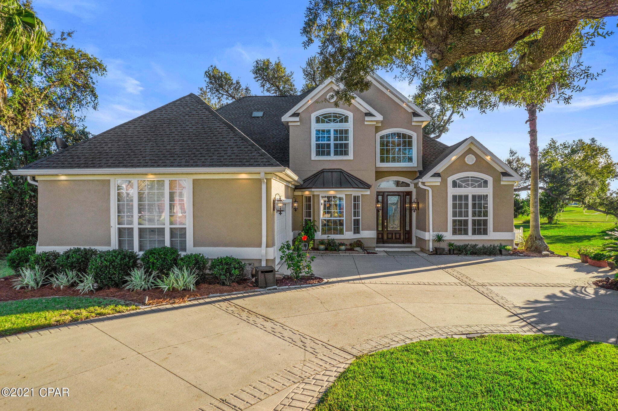 CURRENTLY UNDER CONTRACT, SELLER ACCEPTING BACKUP OFFERS!! A beautiful move-in ready home nestled in Lynn Haven's desired Panama Country Club neighborhood is now available! It features incredible views of our beautiful Florida sunrises through the front door, upstairs rooms, and kitchen dining area. The property also has excellent lighting throughout. The house features an open concept design with views overlooking the golf course.  The kitchen has granite countertops, plenty of cabinet space, a gas stovetop, pantry, & a large breakfast bar.  The family room includes a corner fireplace and a closed-in heated outside patio, not included in the house's square footage. This 5BR/4.5BA home has a new roof, two new A/C units, new appliances upgraded to WOLF brand, all new recessed LED lights, new outdoor and indoor light fixtures, new ceiling fans, and new kitchen solar window shades. The Master bedroom is on the first floor, with a new vanity and cabinets in the master bathroom. The exterior stucco, including doors, baseboards, and trim, are all newly painted. The second floor includes an additional living room area that can be used as a game room or an extra office. It also includes three bedrooms and an outside patio that overlooks the golf course and a beautiful lake.  You need to visit this stunning home in person! The Panama City Country Club community is a quiet and family-friendly neighborhood with an 18-hole course and clubhouse.  The location is convenient and accessible to everything! Homes of this caliber don't come on the market often, so you won't want to miss out! The sellers are also open to negotiating on some of the furniture in the home.  This home shows beautifully and is ready for new owners to settle in. Contact Ayesha Albibi today to schedule a private viewing.