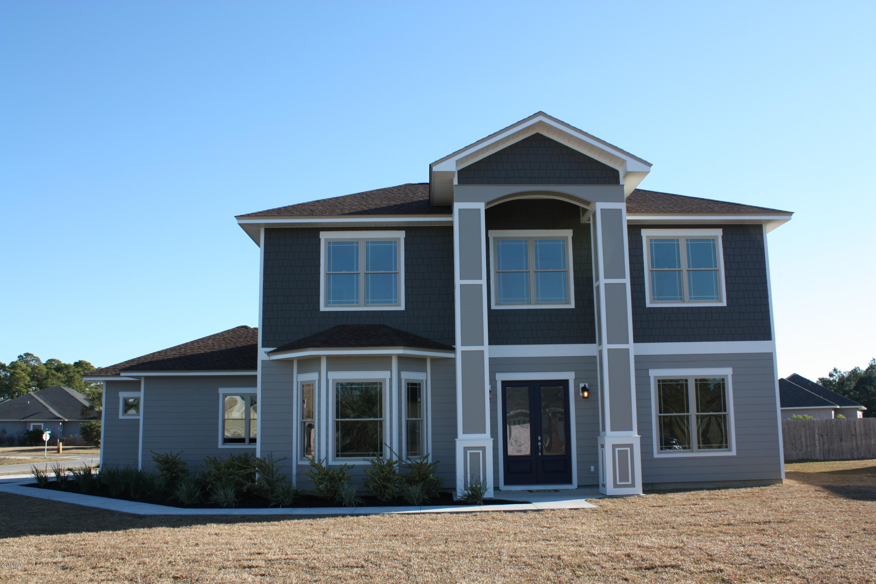 Another quality built, New Construction home in North Colony Club Estates. Golf Course/Water front community. This beautiful open/split plan has 2,363 suare ft, with four bedrooms, three full baths and one half bath. This partial two story home has an open plan with Master bedroom located on the first floor. The second story has two full baths and three large bedrooms. The well equipped kitchen features a large breakfast bar with pendant lights, 42''wood cabinets, stainless appliances and walk-in pantry. There is also a spacious dining area. The luxurious master bath boasts a large walk-in closet, a double vanity with brushed nickle faucets, granite counter tops, garden tub,and an over sized tiled shower. Some of the numerous interior features are, 10 ft ceilings, recessed lighting,crown molding, in common areas, 20" tile and granite in kitchen and all bathrooms. Exterior features consist of a fully sodded and landscaped yard, with automatic irrigation system ,and an extra large 613 ft garage, with 8ft tall garage door. Colony Club is centrally located to the beach, Pier Park and schools. Walk jog or ride your bike down Gails Trails for miles of paved nature trails, and golf on Holiday Golf Course. Agent is related to seller.