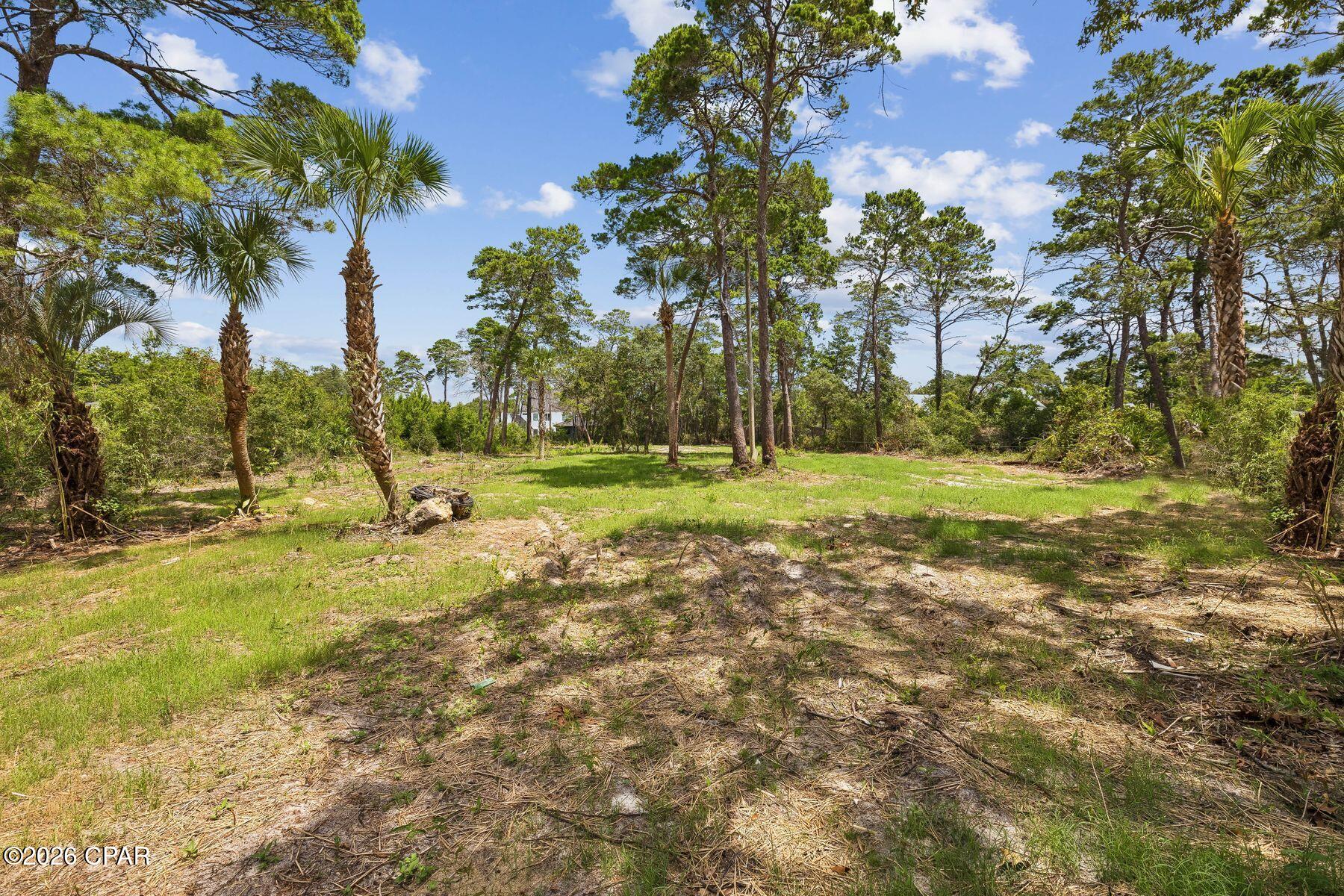 Opportunities to secure an oversized homesite in the heart of Inlet Beach are becoming increasingly rare. Spanning more than half an acre, this exceptional property offers a unique setting for builders, developers or those ready to create a custom coastal residence just minutes from the gulf.

Positioned along a quiet street, the expansive lot provides an ideal canvas for a thoughtfully designed home with generous outdoor living spaces, a resort-style pool, guest accommodations or lush landscaping that enhances the privacy of the property. Electric and water are available at the road, allowing you to begin planning your vision with added convenience.

Whether you're building a full-time residence, a private vacation retreat or an investment property, the size and location of this homesite provide remarkable flexibility. The peaceful setting offers a sense of seclusion while placing you close to everything that has made the 30A corridor one of the Emerald Coast's most desirable destinations.

Public beach access is just minutes away, making it easy to spend your days along the sugar-white sand and emerald-green waters. Nearby, you'll enjoy an outstanding selection of locally owned restaurants, boutique shopping, parks, outdoor recreation and entertainment, with Rosemary Beach, Alys Beach and the vibrant east end of Scenic Highway 30A all within easy reach.

Large homesites in this highly sought-after location seldom become available. This is an exceptional opportunity to create a custom coastal property tailored to your lifestyle in one of northwest Florida's most coveted beach communities.