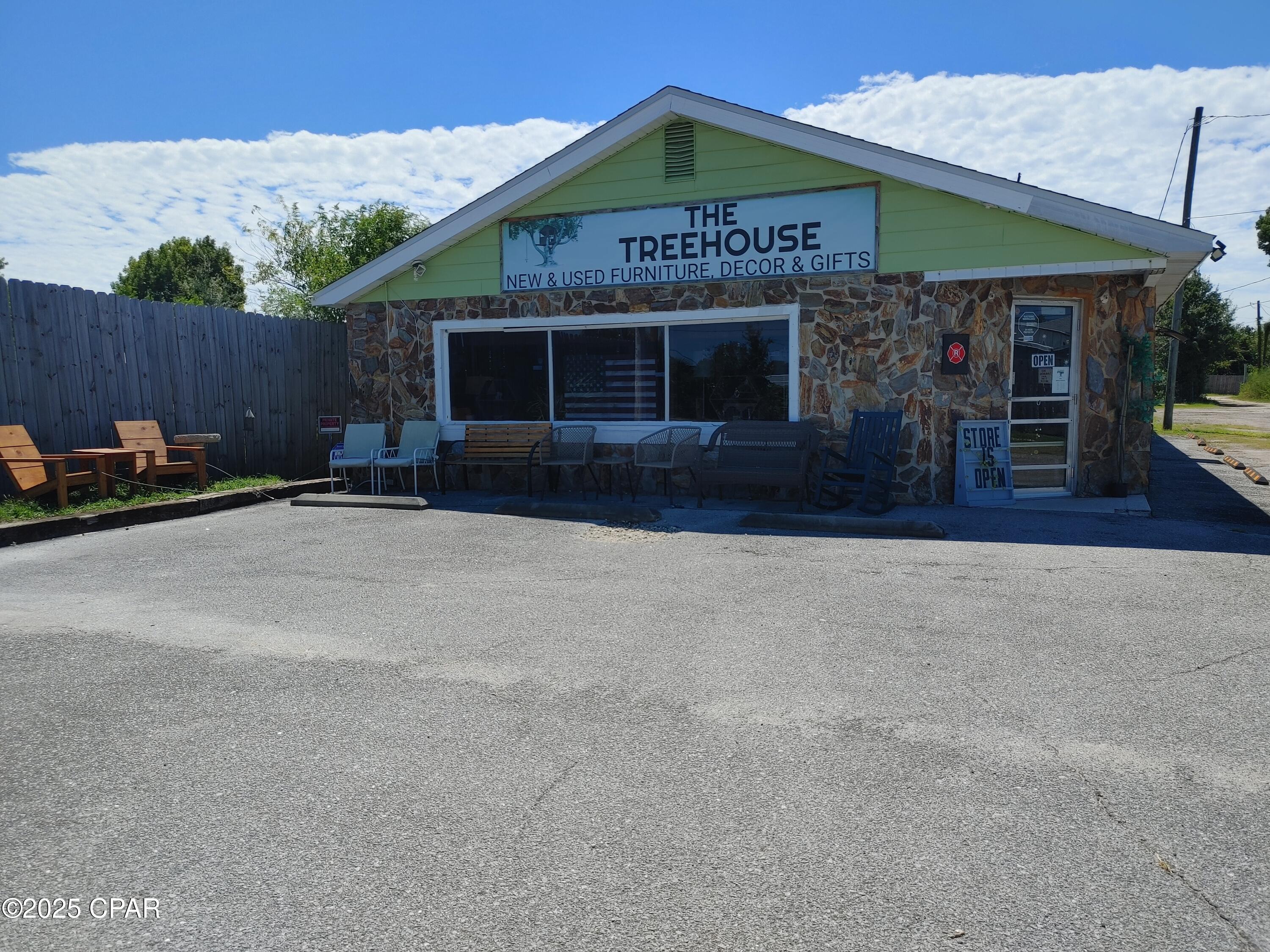 The building has experienced much renovation and kept in its rustic charm and has 4 bathrooms total. Could easily be divided into 2-3 more businesses onsite as the building has 3 separate entrances. Lot features a large area at the back of the property perfect for parking large trucks or cars that need to be kept out of site. Roof was replaced after Hurricane Michael and the building has 3 mini split heat/air units that do the trick for comfortable shopping. This listing is for the real estate only. The business, good will, and inventory as well as the business with the real estate combined are listed separately in MLS system.