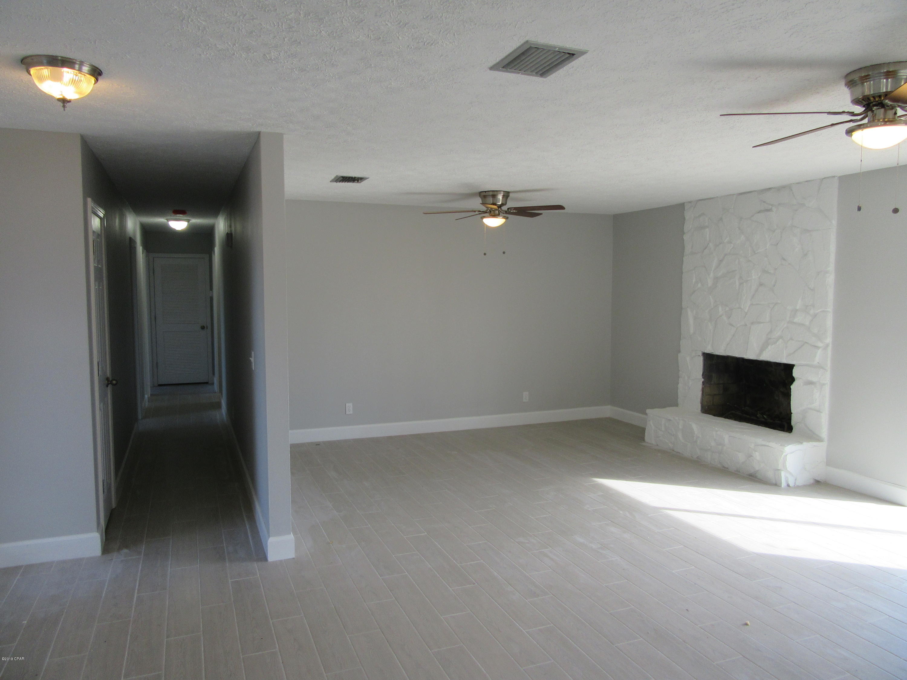 Located in the much desired community of Derby Woods in Lynn Haven, this beautiful completely remodeled 3 bedroom 2 bath home is convenient to shopping, dining, the best schools and centrally located to the Worlds Most Beautiful Beaches and Military Installations. Improvements include but not limited to new wood plank flooring, new paint, trim, upgraded fixtures, granite, and back splashes. This property has an exremely large oversized 2 car garage and extended work station. Living area is a very large open space with a fireplace focal point and a island wet bar for entertaining. All property sizes and ages are approximate, please measure and/or verify if important. School assignments are subject to change, please check with Bay County for most the rent. Pets allowed. Breed restrictions apply with owner approval only.