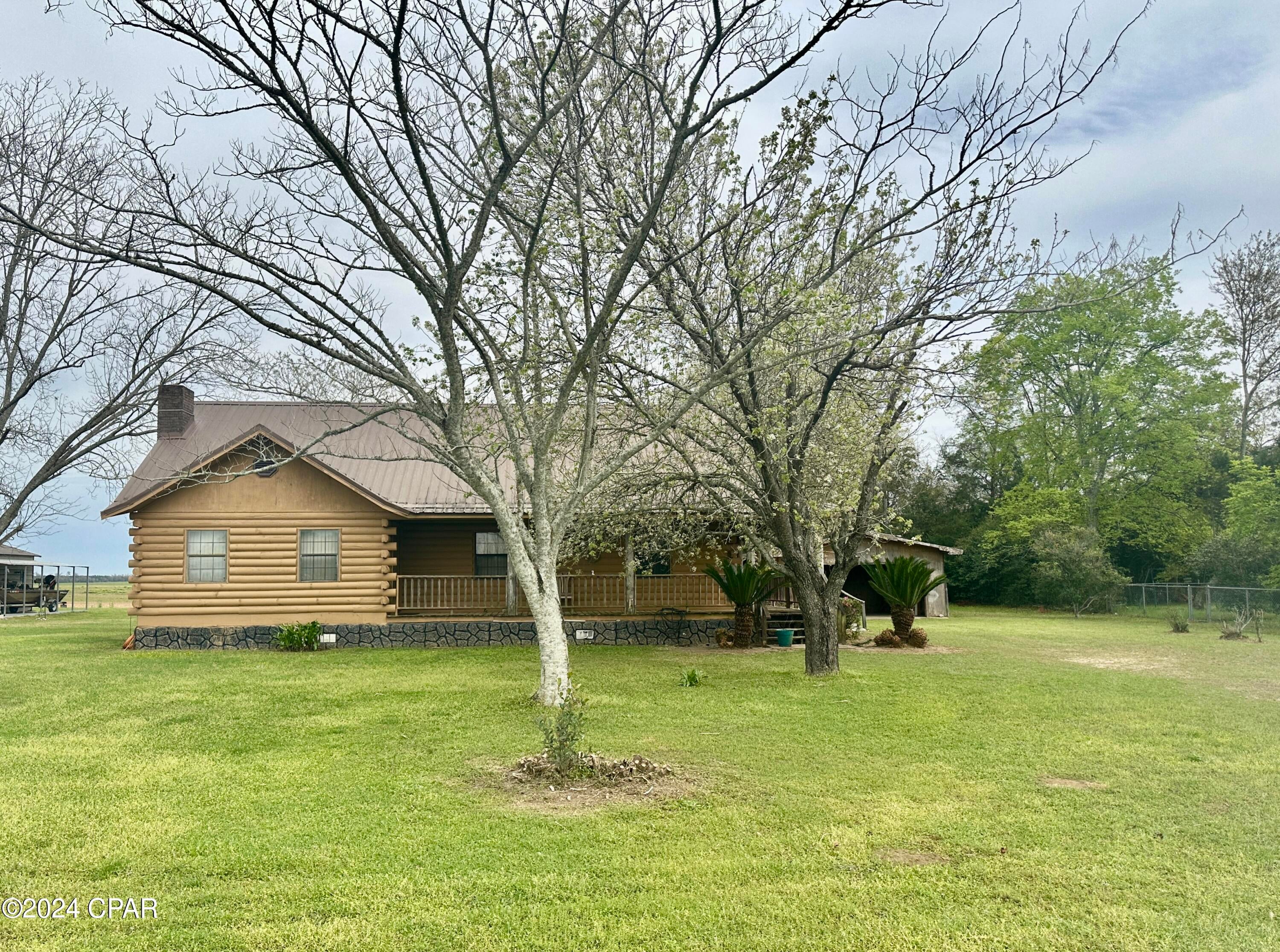 Back on the market due to no fault of the sellers!!  Contingency not met.

A RARE FIND!  This is a great find if you are retiring or just starting a family.   Get that cozy mountain feel while sipping coffee in front of the brick fireplace inside this 2 bedroom 2 bath log cabin with an open floor plan. The location is very close to Marianna, and less than 40 miles to Dothan, Alabama, which has all the shopping and restaurants you need.   Master bath has a garden tub.  The home has a pantry and a spacious laundry room that has enough space to be converted to a small bedroom or nursery.  The cabin features a porch on 3 sides of the house.  The location is less than 5 miles from the public schools and the Mere Sports Complex.  Not many homes are priced under $200,000.  Look at this one!!  

The detached carport is damaged.  If a buyer is seeking VA, FHA, or USDA, the seller will negotiate to have it demolished in order for the buyer to obtain financing.

Otherwise, a conventional or cash buyer may want to keep it and repair it themselves.