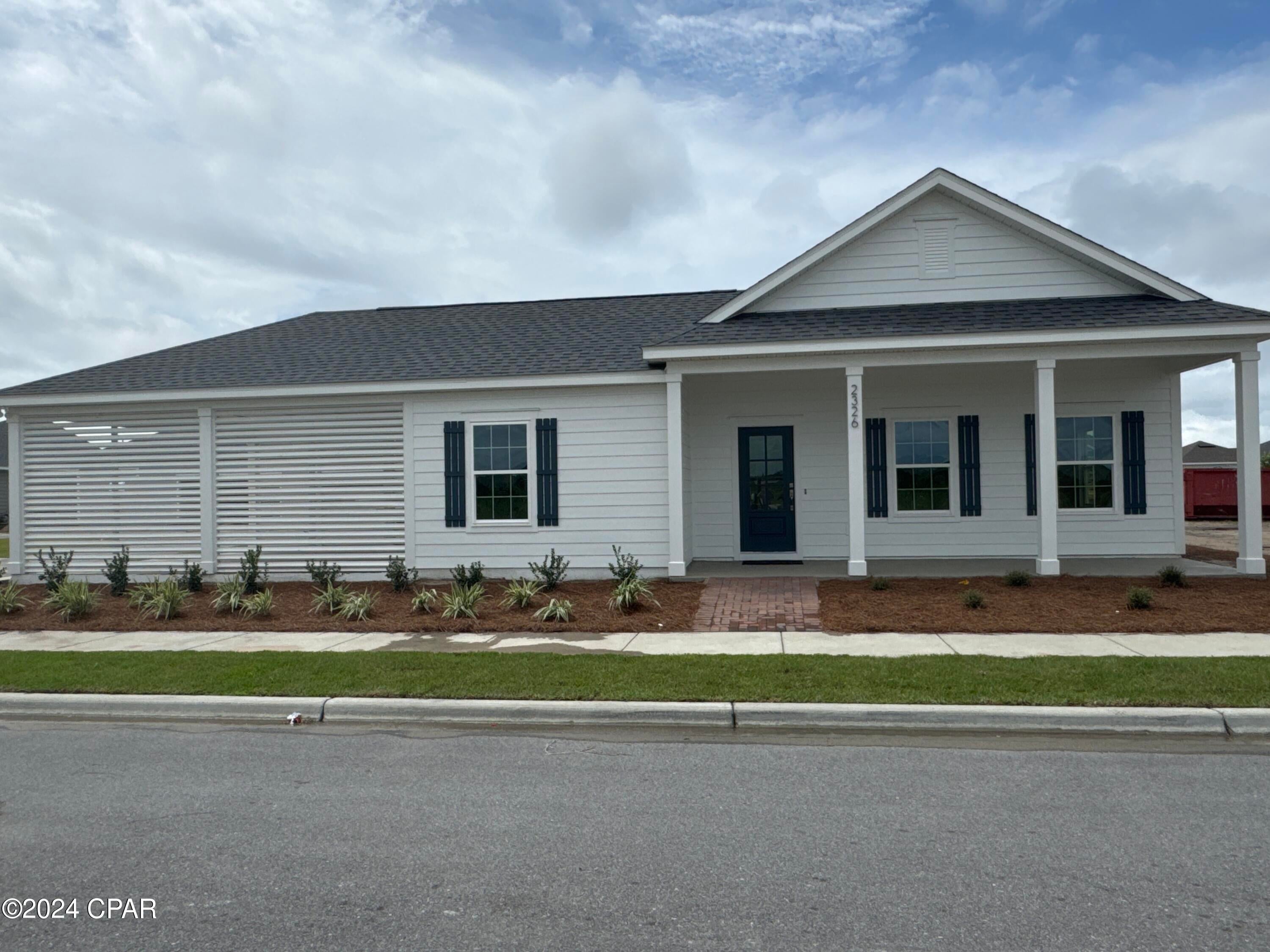 The Elm plan is part of the low-maintenance Cottage Collection in the popular waterfront community of SweetBay! These cottages are perfect if you're ready to stop doing yard work and enjoy the phenomenal lifestyle that SweetBay has to offer! The Elm plan by Harris Doyle Homes is a spacious and open split-bedroom home with a huge front porch, covered rear porch and attached carport. This home includes granite countertops, stainless appliances and luxury vinyl plank flooring throughout the main living areas. The primary bedroom features a large walk-in closet and tile shower. SweetBay is a walkable and golf cart friendly community with unrivaled amenities: dock and boathouse with North Bay access for kayaking, paddle boarding, and fishing, parks, resort pool complexes, basketball and sports court, miles of trails, and planned future amenities including a marina and Publix-anchored town center! New home buyers even get priority access to top-rated University Academy!