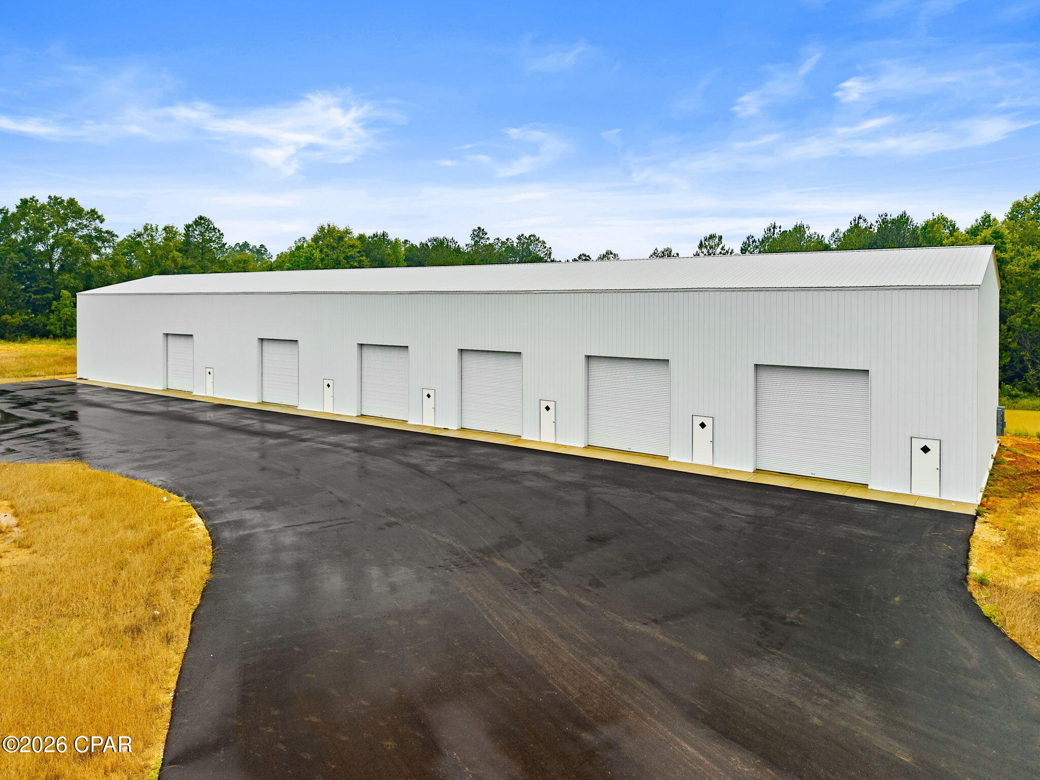 New building Complex: 10,000 SF warehouse/flex space on over 7 acres. Six 14-foot roll-up doors. 26-foot peak, 24-foot eves. Bays could be reconfigured. Currently framed out for one 3000sf, one 2000sf bay, and four 1200SF bays.

2026 Construction. Each bay framed in for it's own office, reception area and restroom. Each unit has it's own, 12ft wide roll-up door, plus a pedestrial door in front and rear. 

Paved entry and parking area. Room to expand as needed. This is a clean slate project, ready for the next owner. Separate electric/meter is needed as well as finishings to office, restrooms, etc... For an in-depth look, schedule a private tour.