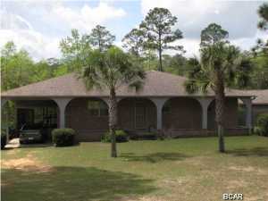 Nice Quiet Private location for Peaceful Living in the Compass Lake in the Hills development in Northwest Florida. Conveniently located just 15 minutes South of Interstate 10 and about 40 minutes North of Panama City. This 3 Bdr 2 Bth Home is on a pretty 1+ Acre lot. Almost 1500 sq ft of Heated & Cooled Living Area with over 2700 sq ft under roof, plus a big 24' x 24' Detached Garage / Workshop. Nicely Landscaped and the Back Yard is Fenced. Enter from Covered Front Porch to Comfortable Living Room with parquet wood floor, then into Kitchen and Dining Area which have tile flooring. Kitchen has Gas Range and Electric Oven plus Island with Breakfast seating. Sun Tunnel above Kitchen Island allows for lots of Natural Lighting. Attached Carport leads to Screened Patio, then into Mud Room