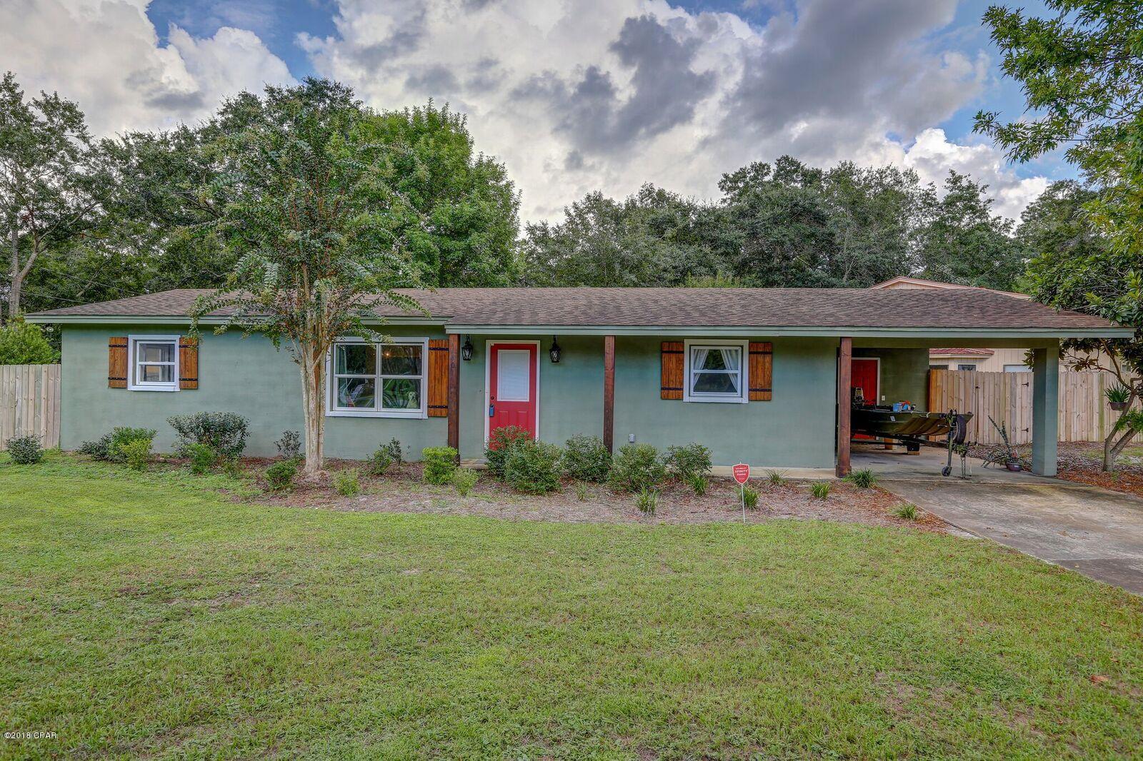 Move In Ready!  New roof to be installed!  No interior water damage according to homeowner!  Beautifully finished Lynn Haven home on corner lot with detached workshop.  The interior of the home features 3 bedrooms, 2 baths, a split open floor plan, 2 living rooms, one of which includes a large wood burning fireplace, a dining area with custom open shelving, and large windows which provide lots of natural light.  The completely remodeled kitchen includes granite counter tops, cabinets with soft close drawers, a center island with breakfast bar, pendant lantern lighting, open custom wood hanging cabinets, and stainless steel appliances.  The hall bath has been remodeled to include new vanity, fixtures, and a walk-in tiled shower with small cobble stone flooring.
