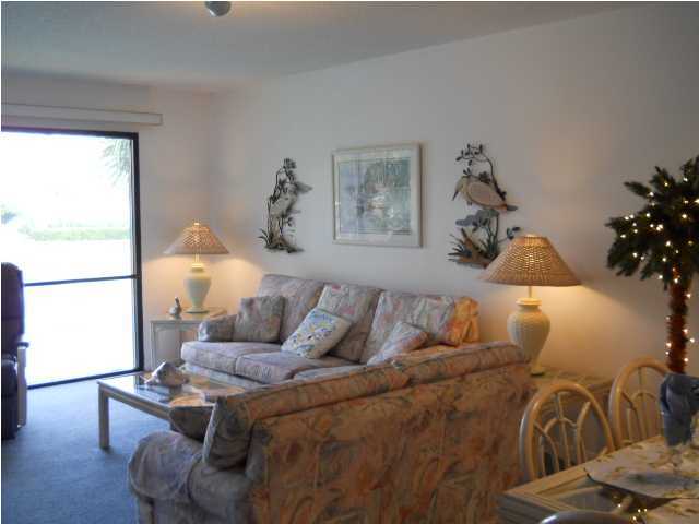 This lovely Villa is in one of the quietest and most convenient locations in the complex. It is located close to the entrance, the conference center AND the Pedestiran Brige with an easy walk to the Beach. It is Nestled between a pond a several pools with a tropical view. This condo has a BRAND NEW A/C UNIT - June 28, 2014. Other Updates to this unit in May 2014 are: New Washer and Dryer; New Glass Sliding Door to the Patio in the Guest Bedroom, New Small Appliances, New Hinges on all Doors, New Bathtub Drain, New Comforters. This condo sits on one of the prettiest lots in the complex. It is on the 2nd floor, next to the west end of the building. It is a tropical setting and from your Living Room/ Dining room/Kitchen and Master Bedroom you have a beautiful view of a large pond with