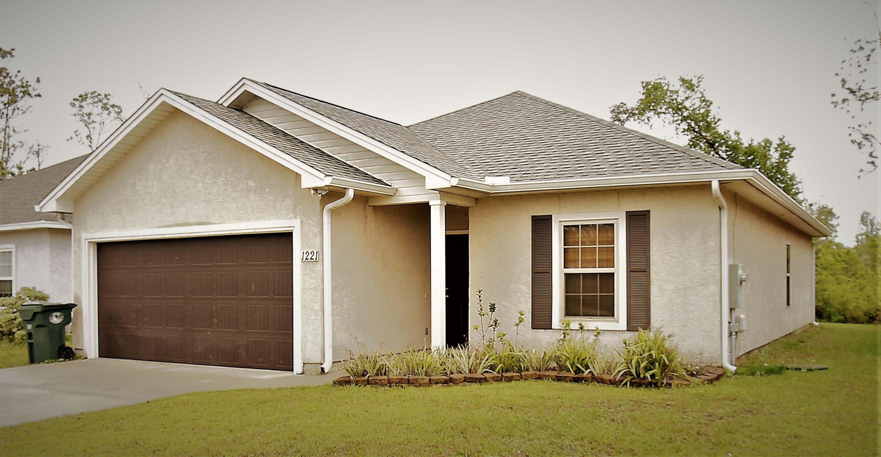 1221 E. 26th Street, Lynn Haven, FL 32444 - What a lovely home in a great location! Home features a large open floor plan, 3 bedrooms and 2 bathrooms. Kitchen is equipped with all Whirlpool stainless appliances.  Carpet and LVP throughout the home.  Between the kitchen and garage, where you can drop your laundry is a HUGE laundry room and pantry.  Master bedroom features a walk-in closet and a lovely master bath with a shower AND a separate tub! Plenty of storage throughout the house and it is MOVE-IN READY! Come see today! This one will go fast!