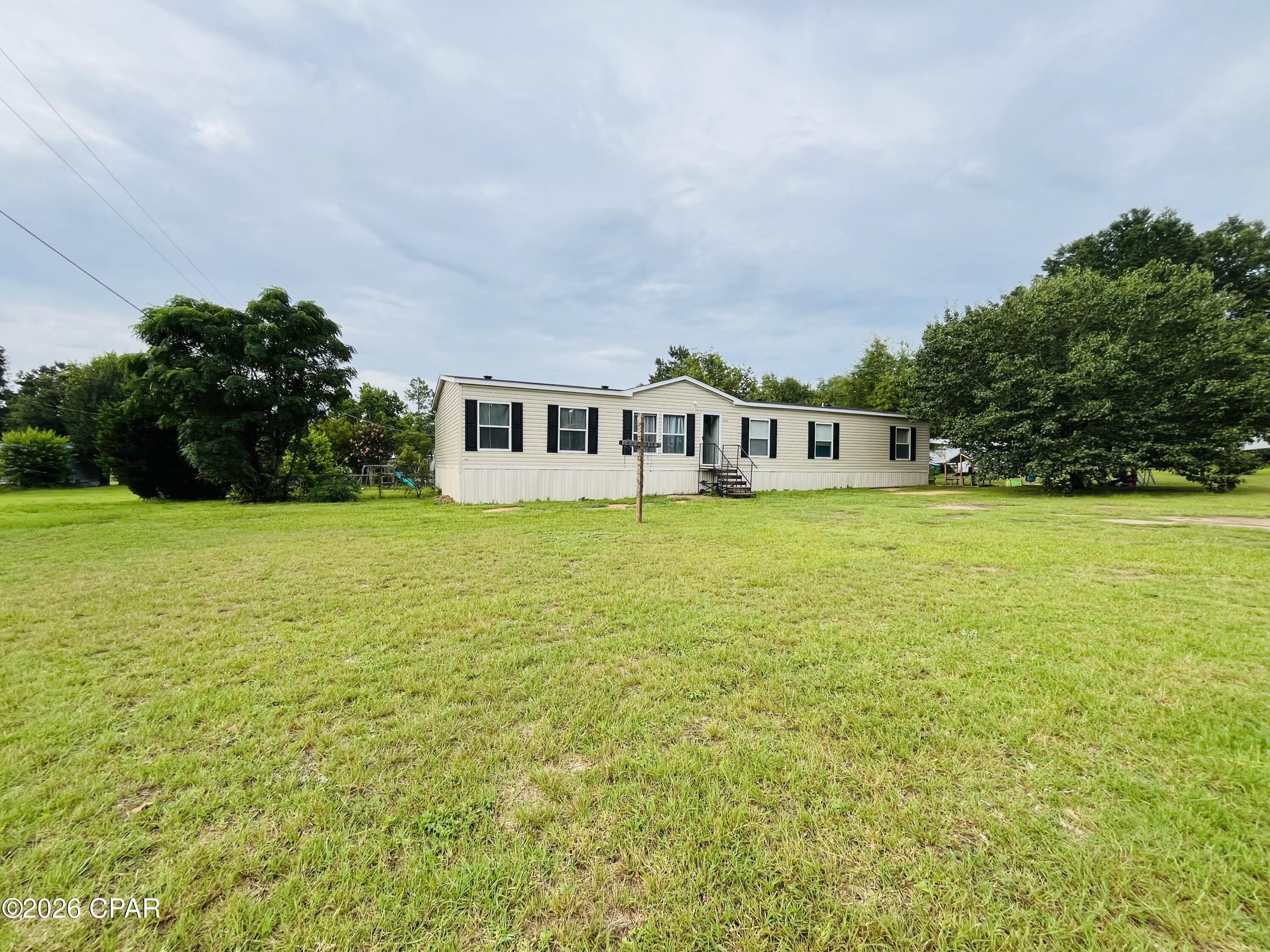Just minutes from the public boat ramp on beautiful Lake Seminole, this stunning like-new home offers over 2,400 square feet of thoughtfully designed living space with 5 bedrooms and 3 full bathrooms--perfect for growing families, multi-generational living, or anyone who simply desires room to spread out.

Situated on approximately half an acre, the property features a spacious, fully fenced backyard with plenty of room for children, pets, outdoor entertaining, or even a future pool. Nestled in a peaceful, family-friendly neighborhood, this home provides the perfect balance of quiet country living and convenient access to nearby amenities.

Ideally located within approximately one hour of Tallahassee, Panama City, and Dothan, you'll enjoy easy access to the beach, shopping, dining, healthcare, and employment opportunities while returning home to the tranquility of NWFL living. Whether you're an avid fisherman, boating enthusiast, or simply searching for the perfect place to call home, this exceptional property offers the space, comfort, and location you've been looking for.

Don't miss your opportunity to make this beautiful home your own--schedule your private showing today!