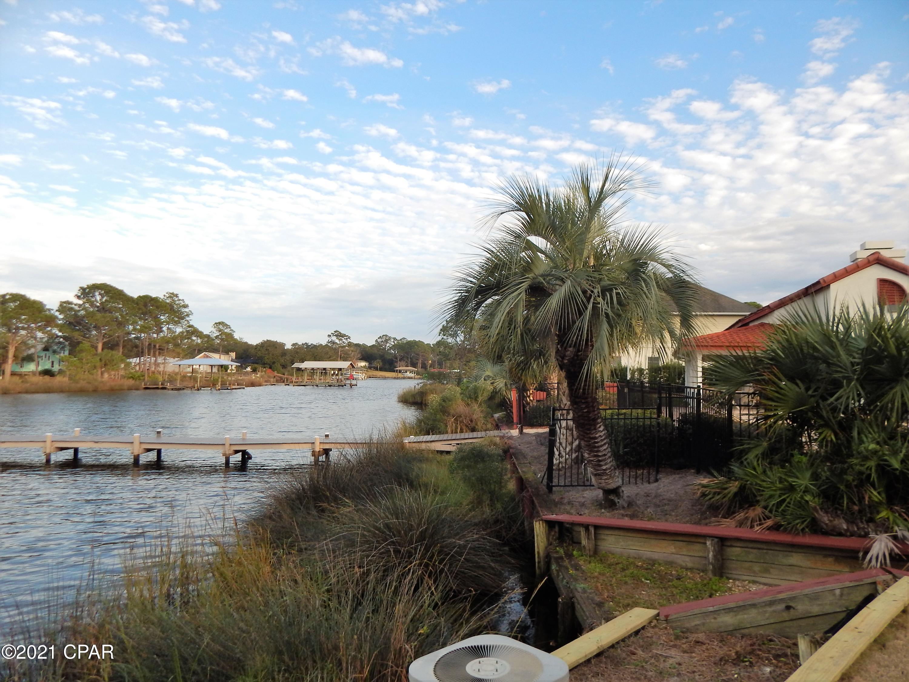Excellent opportunity for a vacation home, primary residence, or for a resort rental investment.  Lagoon front condo with access to the Gulf  & a beautiful view in a community with many amenities-- pool, dock , tennis courts, & much more. All of this & less than 2 blocks to the beach.  Located on the east of Panama City Beach close to the marinas, great restaurants, entertainment, & the Navy Base. Villas of St. Thomas is nestled in a quiet gated communty, but is very close to all of the activities available at Panama City Beach. This 1st floor condo is perfect for walking right out from your covered patio to Grand Lagoon.  Vacation rental with very good income potential.

All information & measurements are approximate & should be verified if important.