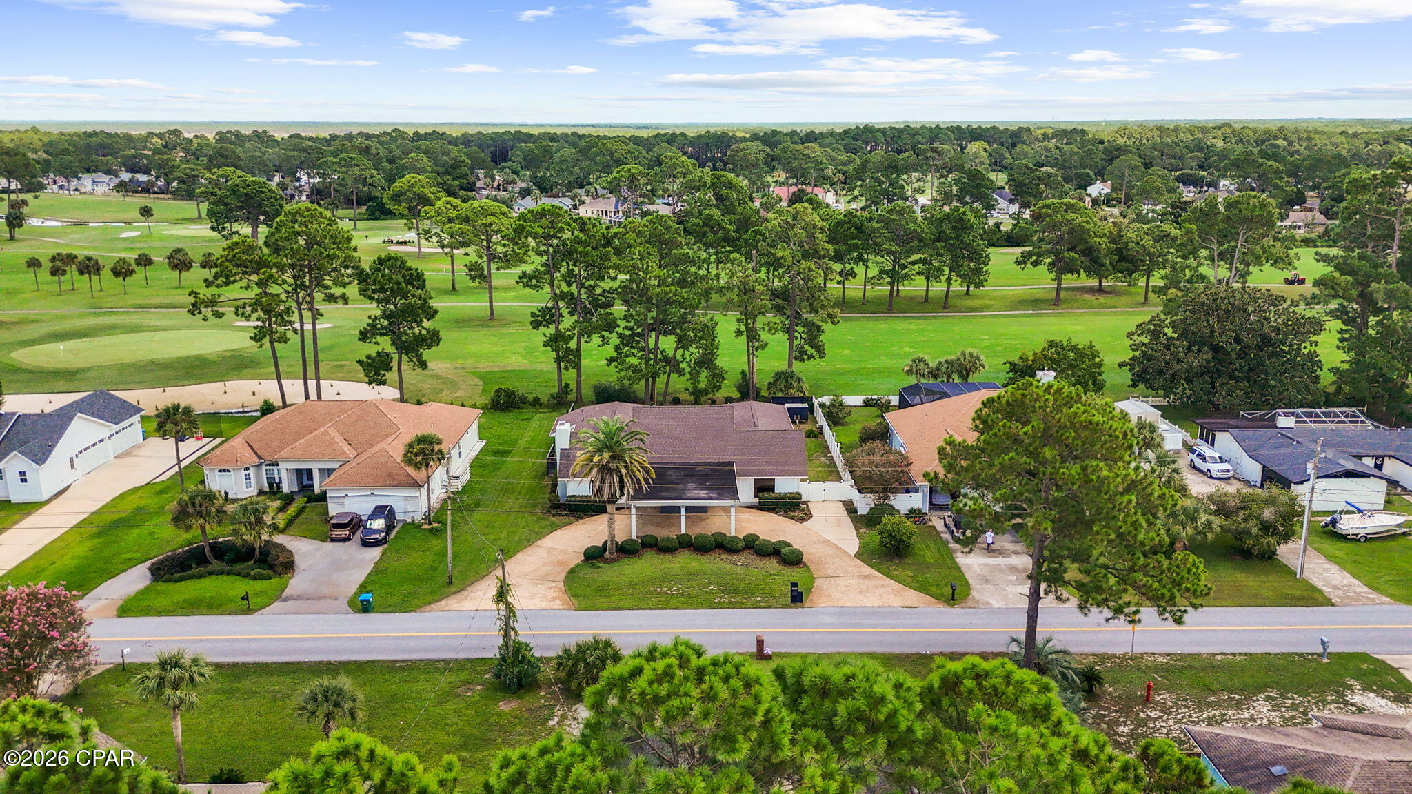 Beautiful custom home overlooking the 11th fairway at Legacy golf course. Enjoy gorgeous views from the 2nd story balcony. Large circle drive with covered parking. Enter into a bright and airy main space with plenty of natural light. Fireplace on the left and a staircase on the right leading to the upstairs recreational space with wet bar. The spacious 1st floor main space features luxury vinyl plank. Chefs' kitchen featuring custom cabinetry, an island, apron sink and quartz countertops. Walk-in pantry with separate closet, could be a butler's pantry. A half bath for guests, spacious laundry room and 20x10 office round out this wing of the home. Exquisite master suite offering a spacious walk-in closet with built-ins. Double vanities, huge custom shower, and freestanding tub. The perfect place to relax and unwind. The two guest rooms are nice sized with a jack & jill bath. Both have their own sinks. Upstairs could be a 4th bedroom if wanted. The middle of the home is almost like a courtyard with 5 sets of sliding glass doors to access. There is an attached workshop for tools or a golf cart. Nice sized backyard. Custom chickencoop for farm fresh eggs. A walk-in attic with enough storage space for any family. You really must see to appreciate all this home has to offer. There is even a hidden room if you can find it!! Great proximity to Pier Park and the World's most beautiful beaches. Schedule your visit before its gone!