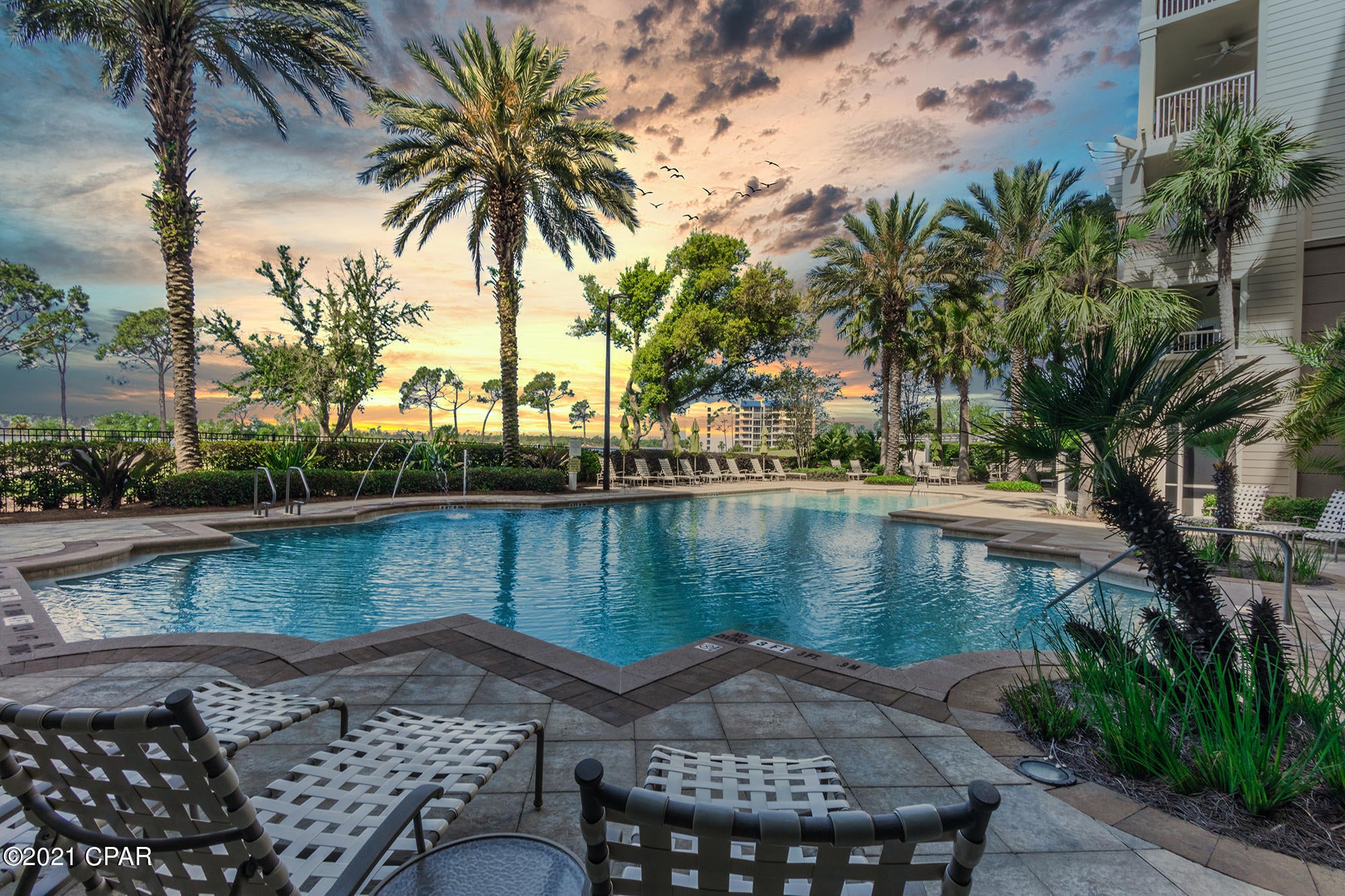 Location, Location, Location!  This luxury condo is in ''The Grand at Bay Point'' and directly overlooks the Grand Lagoon and the 4th and 5th holes of the Jack Nicklaus Golf Course.  Bay Point is minutes from the white sandy beaches, shopping and restaurants in Panama City Beach and this gated community features 24-hour security, which makes it ideal for your primary residence or second home.  



With it's perfect first floor location, you can walk right out your back door and in just 6 steps you can jump in the huge resort pool!  You can sit on your screened in patio sipping your morning coffee while the kids play in the pool.  Plus, with this location, you are just a few steps away from sitting by the fire pit with a cool beverage, enjoying the hot tub or firing up the grill! The fitness center is also located on the first floor.  You never have to wait on elevators!  

The Grand does not allow short-term rentals, making the building a peaceful, quiet resort comprised of primary residents, long-term renters and owners who use their unit as a second home.  It also means that even though this unit is located on the first floor, it is not in a high traffic, noisy location.  This unit includes a reserved parking space just a few steps away from your front door.  It also includes a deeded, generous-sized, climate controlled exterior storage room.  

This condo features 2 bedrooms, 2 baths, and a "flex space" that can be used as a bunk area, office, media room or additional dining space.  The spacious master bathroom features a separate shower and garden tub. The guest bedroom is large enough for two queen sized beds. It is also one of the few condos that has 10-foot ceilings and 8-foot doors, which provides a super spacious and open feel.  Flooring is all tile and LVP (no carpet) and AC is from 2018.  Unit is offered fully furnished with American Drew furniture and custom window treatments. 

All condominiums at The Grand also feature leak and humidity sensors with an auto-water shut off feature if a leak or issue is detected. 

The Grand is part of the Bay Point Master Association, which provides gated security and hosts many great community events for the whole family to enjoy.  Bay Point is home to a Jack Nicklaus golf course and is rated as one of the best golf courses on the Gulf Coast, with its challenging and scenic waterfront holes.  The community also features a tennis club (additional fees apply).  The Bay Point Marina is currently under re-construction and will give you the ability to lease a slip and keep your boat only minutes away.  

Please note:
***This building does NOT allow short term rentals.   
***In addition to the quarterly HOA fee, there is a $1325 annual fee to the Bay Point Master Association.  
***Storage unit is located on the 3rd floor in the secured, climate controlled room to the right of the elevators. 
***All measurements are approximate, please verify if important.