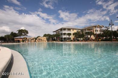 Beautiful well cared for condo in popular Island Reserve.  This unit is located in one of the best locations in the whole complex.  The parking garage is all under roof and connected to the breeze way straight to the first floor unit.  The unit is closest to the hot tub and just a short walk to the pool.  The pool is visible from the living room and bedroom.  This condo feels more like a home than a typical condo unit.  It has many high end features such as 10' ceilings, spacious living area with crown moulding, bamboo hardwood flooring in living/dining areas, acoustic floor matting (engineered to reduced impact noises such as foot traffic), terra stone tile flooring in kitchen & baths, plush carpet in bedrooms, granite counter tops, fine detailed cabinetry, designer stainless refrigerator with ice maker, gourmet cooktop with self cleaning oven, built-in microwave, dishwasher, garbage disposal, premium plumbing fixtures, garden tub in master bath, upscale decorative lighting & ceiling fans, pre-wired telephone, cable, internet, pre-wired individual alarm system, full size washer/dryer, 2 parking spaces, and a private balcony.  Island Reserve offer so many amazing amenities such as gated community, clubhouse & recreational facilities, 1 acre resort style lagoon pool with rock waterfall, interactive fountain, natural ponds with water features, serene courtyard , fountains, state-of-the-art fitness facility, indoor basketball, volleyball, aerobic court, billiard & game room, media center with 100" theater screen, parking garage with direct access, conveniently located near shopping, restaurants & The World's Most Beautiful Beaches!  The HOA fees include all the facilities including water, sewer and trash.  If you were to pay for these things separately then it would come out to much more.  Do not delay, this is the best unit in the best location in Island Reserve!