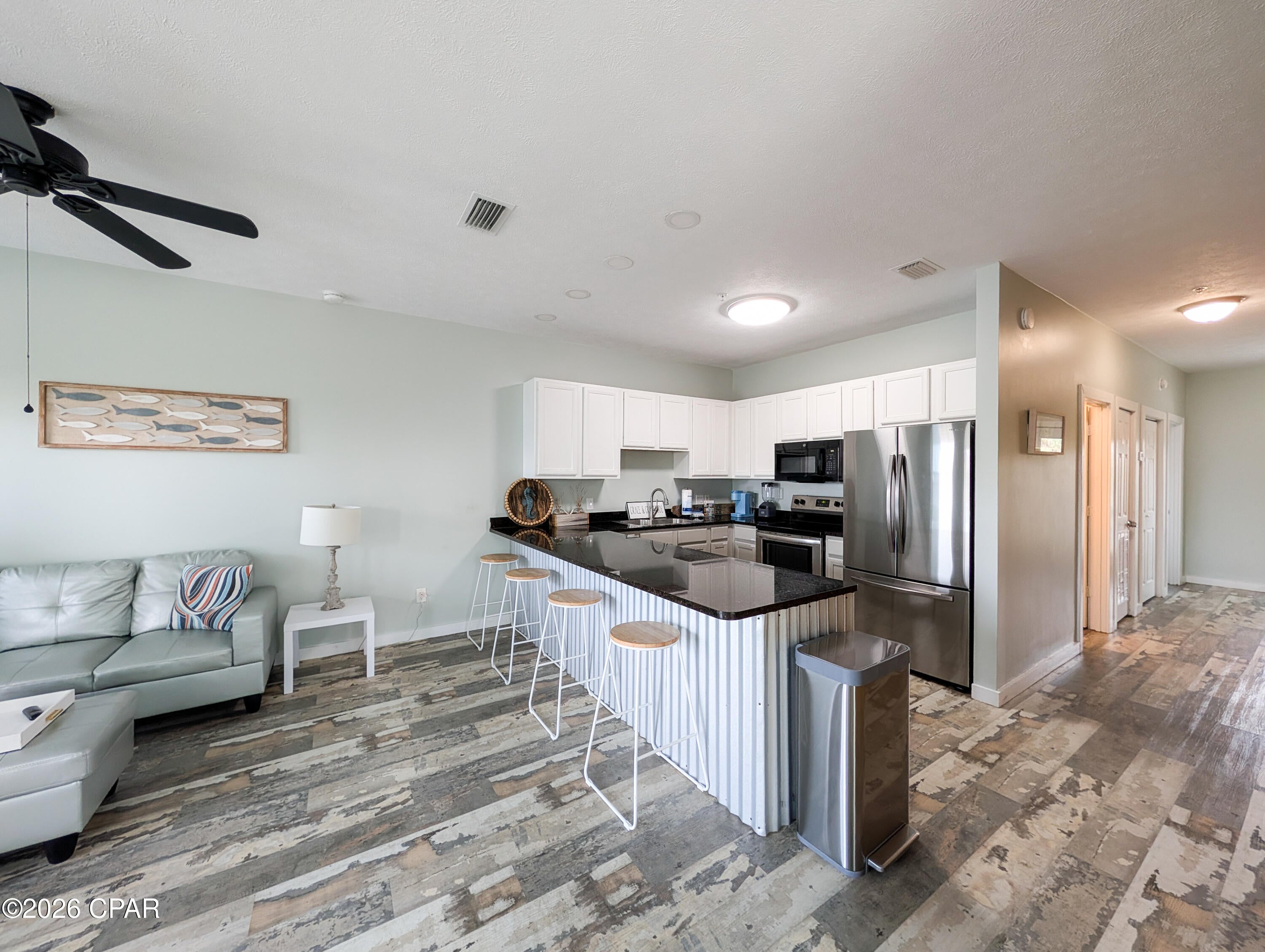 This fully furnished, rental ready townhome is less than 2 blocks from the sugar white sands and emerald green waters!  Completely renovated in 2025 with new beachy decor, new furnishings, fresh interior paint throughout, and fresh exterior paint.  The home also features a new roof, and has been updated to all current codes, including a newly redone sprinkler system!  Best of all, there are no HOA dues!!!  The property includes a 3 bed, 3 bath main home, with a separate, private efficiency studio and 1 full bathroom.  2 properties to rent!  Live in one, rent the other, rent them both either short or long term, or use the entire property as your primary residence.  There are tons of options to choose from!  Just as you enter the primary 3/3 portion of the property and continue to the second level, there is a guest bedroom and full bath along with a large living, kitchen, and dining area.  The second level offers two covered balconies.  The rear balcony is perfect for the guest bedroom occupants to have their own private space, while the front balcony is spacious enough for lounging, or even outdoor dining.  On the third level is a large guest bedroom with an attached full bathroom, and the oversized primary bedroom with its own full bathroom including double vanities and a soaker tub.  From the primary bedroom there is access to the large third floor balcony with beautiful Gulf and sunset views!  Around the rear of the property is the separate studio.  With its own private access, large covered porch, and full bathroom, it makes a great short or long term rental.  The studio also has the use of the fenced in back yard.  There is a one car garage, and parking for several more vehicles in the driveway.  Just a short, 2 minute stroll to the beach (accessed by one of the several beach access points located on Front Beach Road. See photos), and 1 block from the Salty Goat Saloon featuring live, local entertainment nightly, and a full bar and grill.  Plenty to do nearby, easy access to all PCB, centrally located, this property offers all you need for the perfect primary or investment opportunity!  Contact me anytime for more information, and especially to set up your own private showing!