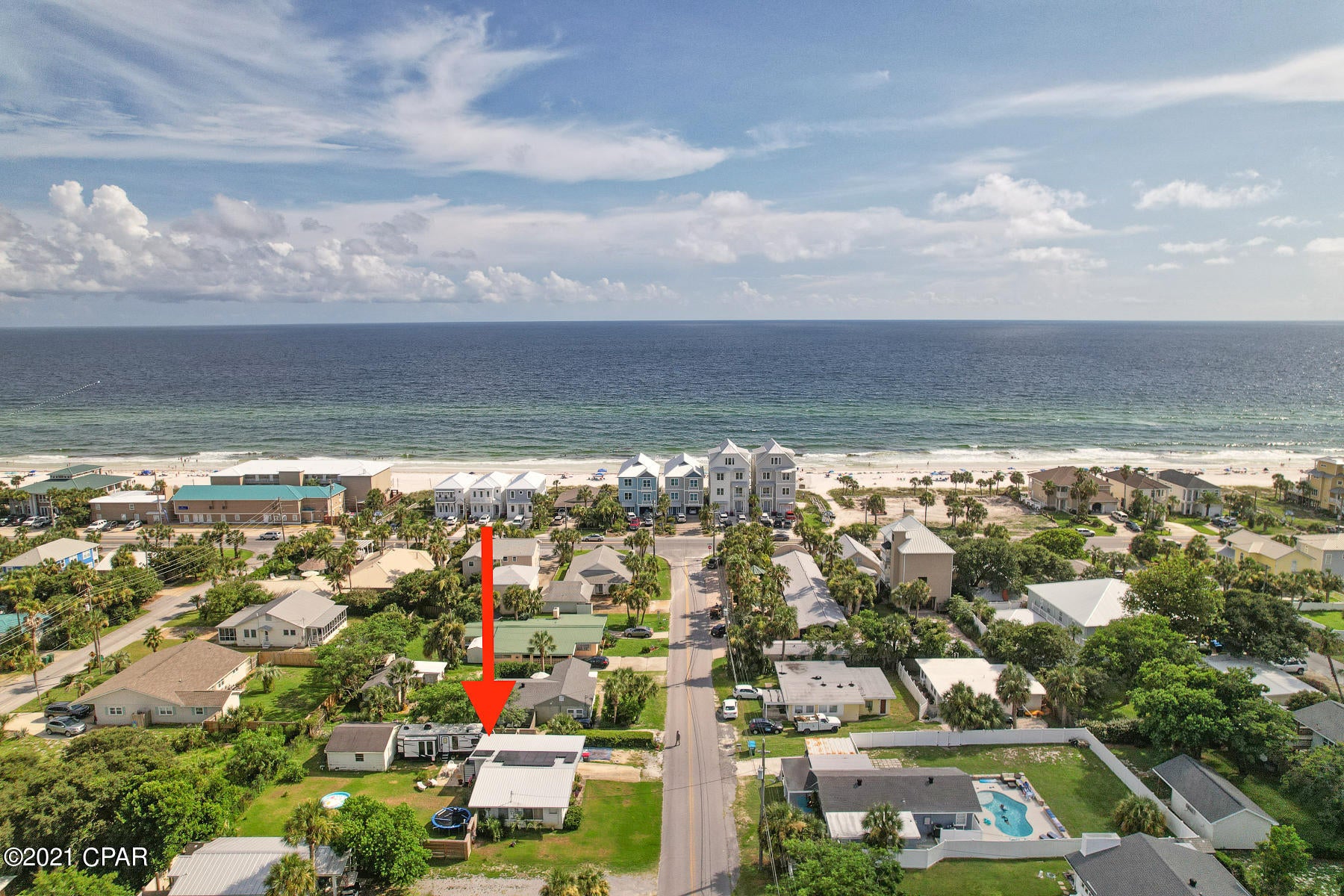This property is less than a half mile away from the beach. Perfect for short term rentals or a vacation home. This centrally located property is a 3 mile drive to  pier park or 3 mile drive to the 30a corridor. This concrete block house has a huge fenced in back yard lovely outdoor seating areas and a detached garage that could be converted into a mother in law suite.
