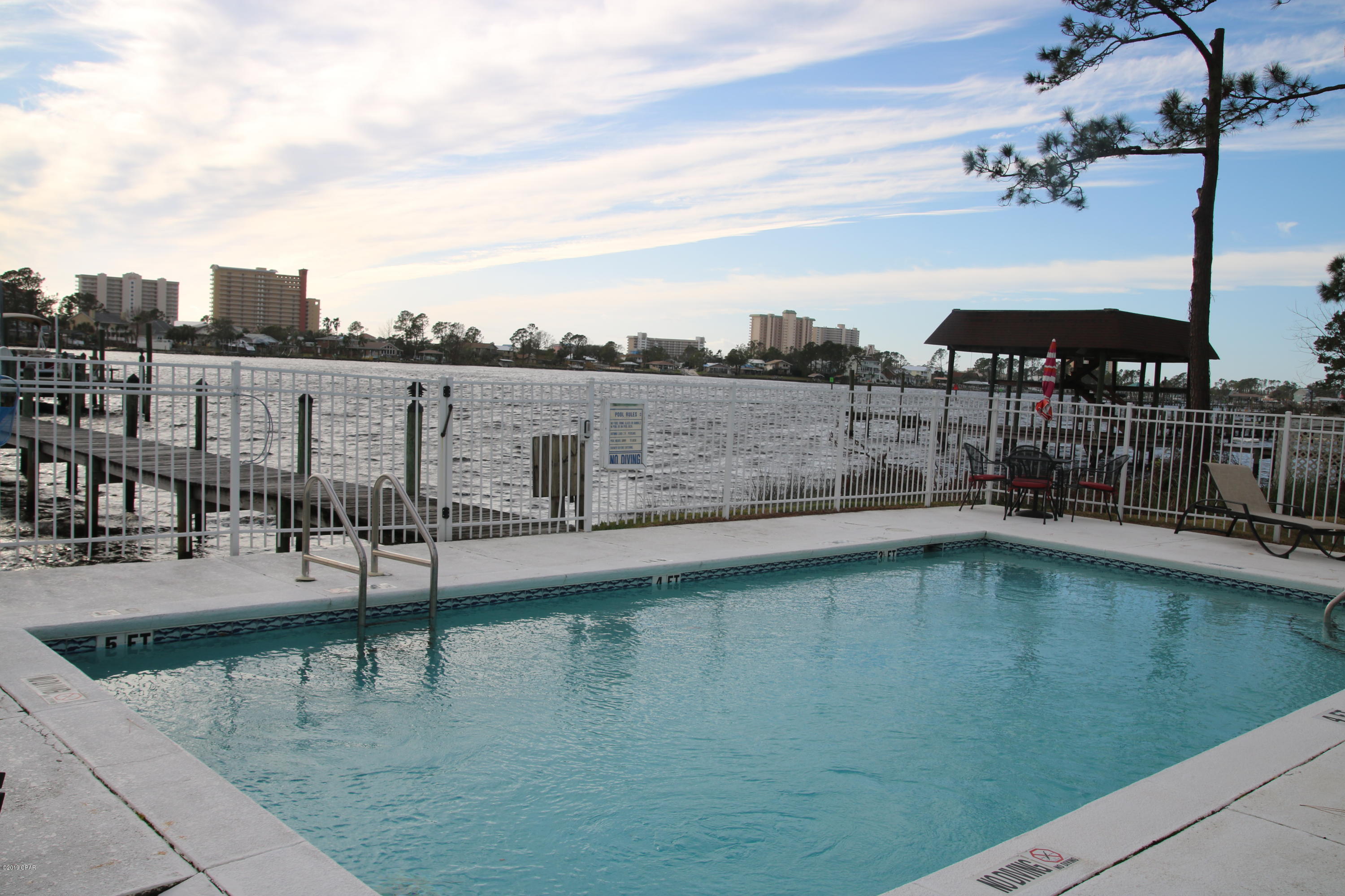 GARAGE!! VIEW of the LAGOON!! Fantastic 2/2.5 townhome, open floor plan, porch AND balcony with a view of Grand Lagoon! Both bedrooms have their own bathrooms, master with a double vanity! Kitchen is perfect for entertaining.....has a breakfast bar, stainless appliances, GORGEOUS washer and dryer, plus looks out towards the water!! There is a dock, swimming pool on the Lagoon - what more could you ask for!?? Location is so convenient, can be at the BEACH, or over the bridge in minutes!! Call your favorite Realtor to see this one!! All sizes to be verified by buyer.