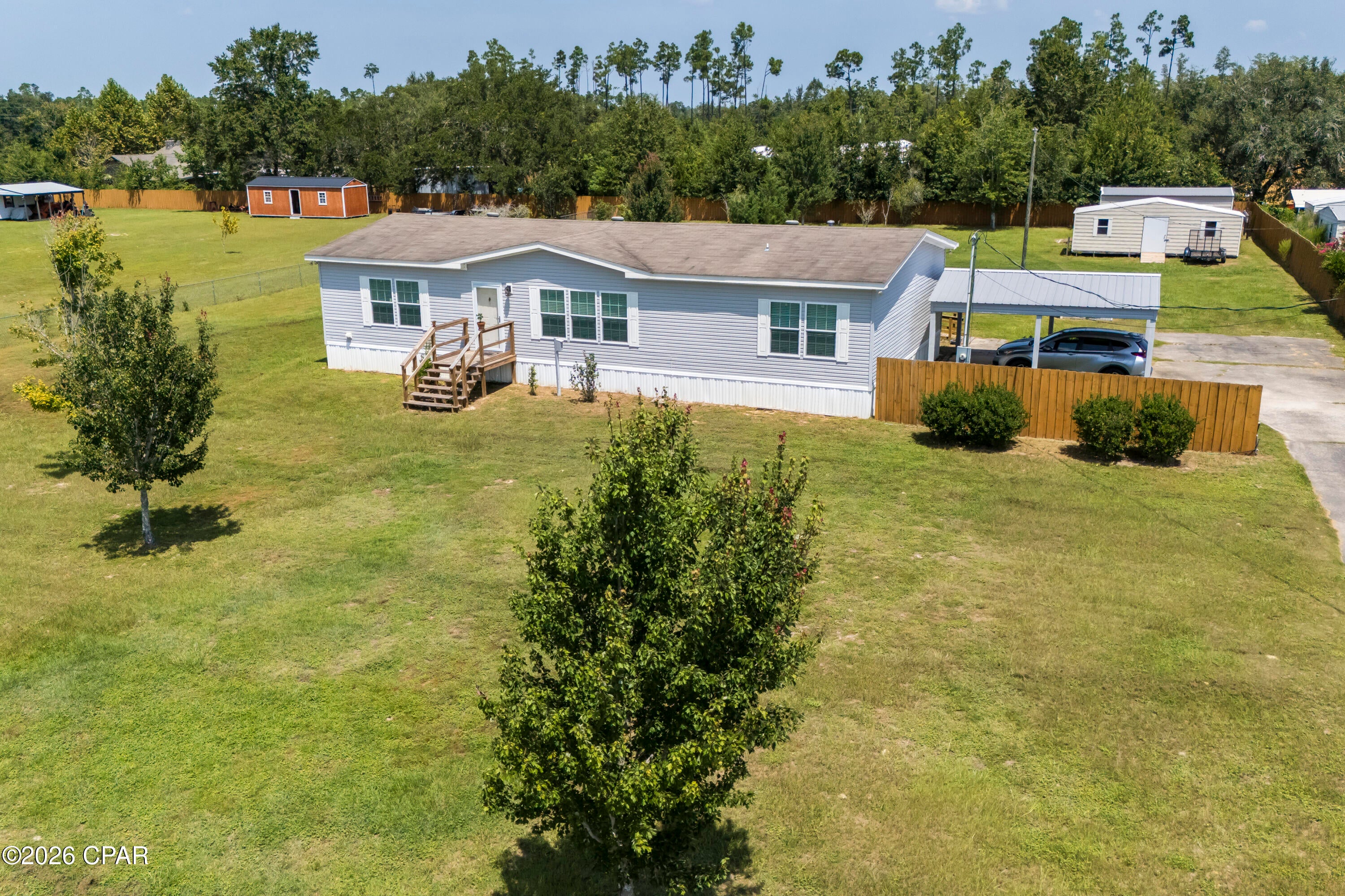 COUNTRY LIVING WITH DEERPOINT LAKE JUST MINUTES AWAY! This immaculate 3 bedroom, 2 bath home offers peaceful country living, a spacious fenced yard, and easy access to Deerpoint Lake. Located approximately 2.3 miles to Ira Hutchinson Park and Boat landing and only 2.8 miles from Highpoint Boat Landing, this is the perfect location for boating, fishing and making memories on the water. Inside, the open floor plan connects the family room, dining area and kitchen. The kitchen features abundant cabinetry, generous counter space, breakfast bar, and a window perfectly placed overlooking the backyard. The spacious primary suite includes a large walk-in closet and private bath with double vanities, a dressing area, linen closet, and a tiled walk-in shower. The split-bedroom design provides two additional bedrooms, a guest bath and the laundry room on the opposite side of the home. Outside, enjoy a large fully fenced yard, detached garage/storage building, and covered parking. Conveniently located on a paved road near shopping and restaurants while offering the peace and serenity of country living. Bring your boat, fishing poles, and enjoy the lifestyle you've been looking for!
