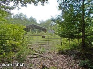 This site is ready to build your dream home on, it is cleared and has a 36x36 pole barn and a 10x20 storage shed with a loft, the lot is high and dry and has a nice slope to the road making it a beautiful home site. There are lots of large oaks and fencing and a culvert ready to use, All the amenities of Compass Lake go with this lot. Call agent before you go onto property please.