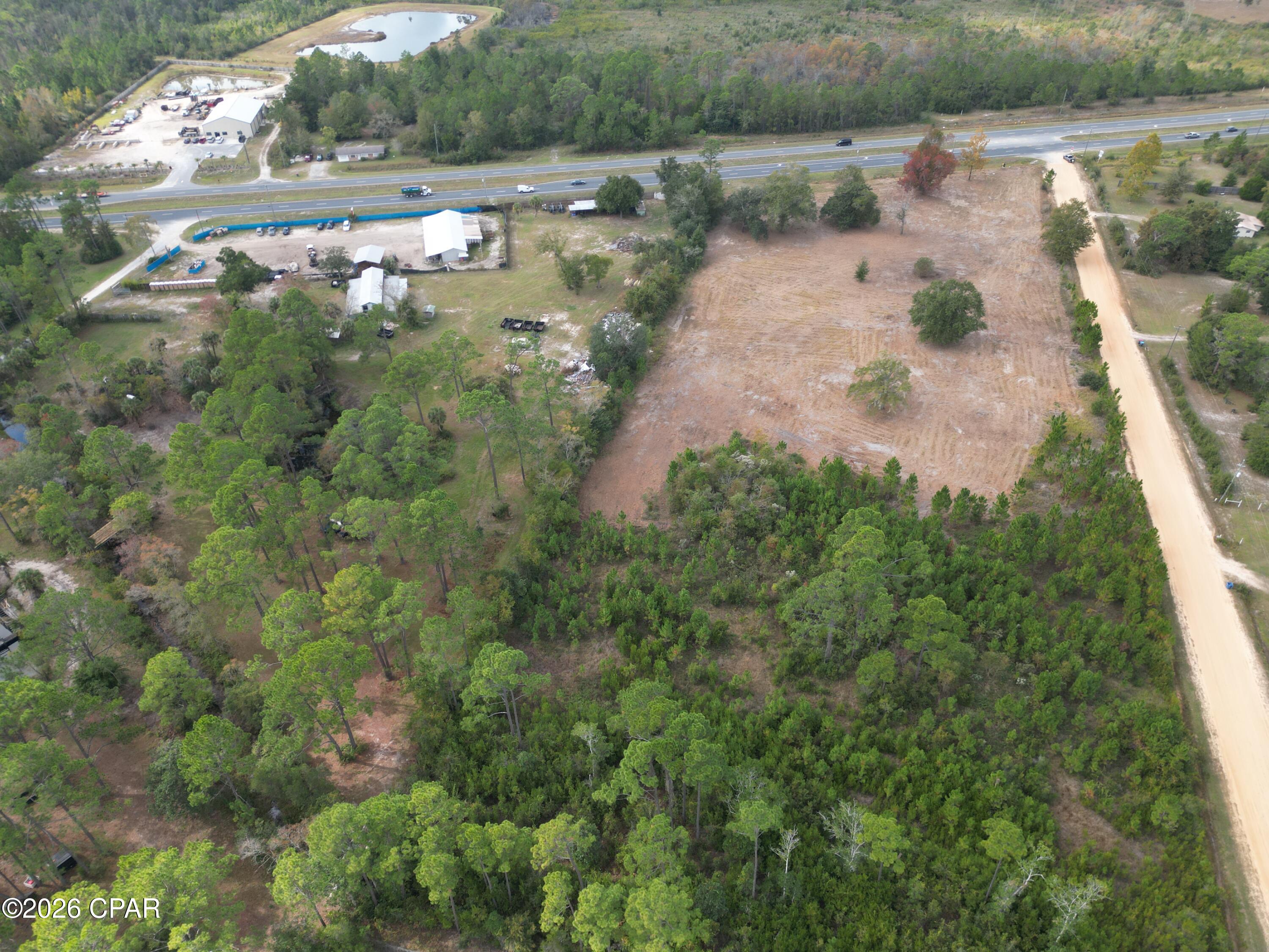 This 4.4± acre partially cleared commercial parcel represents a prime investment opportunity in one of Bay County's fastest-growing corridors. Strategically positioned directly off SR Highway 77, the property offers exceptional visibility, strong traffic exposure, and convenient regional access.
Located in Southport, just three miles north of Lynn Haven/Panama City, the site benefits from immediate proximity to established neighborhoods, multiple emerging residential developments, and a planned future retirement community. Surrounding growth to both the north and south positions this parcel squarely in the path of continued expansion.
With direct connectivity to Panama City Beach via Highways 388 and 79, and approximately 10± miles from Northwest Florida Beaches International Airport, this location provides strong regional draw and long-term commercial viability.
As residential density continues to increase in the area, demand for retail, service, medical, and professional businesses is expected to follow -- making this an ideal site for development or future inestment.
An additional 3.5± acre parcel located directly in front of this property (with 410 feet of Hwy 77 road frontage) is also available, offering expanded scale for larger commercial projects.
Claim your spot in one of Bay County's rising areas! Contact us today for additional details.
Key Features:
*Development-ready acreage
* In the direct path of expanding commercial and residential development 
* Near established neighborhoods, new communities, and a planned retirement development.
* Just 3 miles to Lynn Haven/Panama City and approximately 10± miles to Northwest Florida Beaches International Airport.