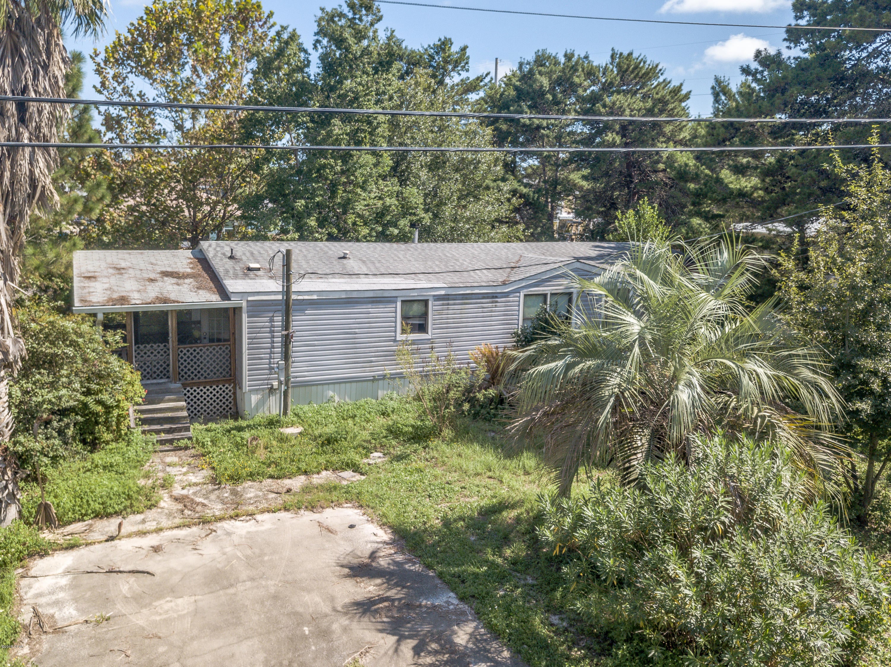 Looking for an investment property?  Here is an opportunity to purchase a fixer up'er in the Sand Dollar Estates in Laguna Beach. The mobile home needs roof repair, interior repair, and flooring. Only 5 minutes to the beautiful sugar white sands of the Gulf of Mexico and a short 5 minute drive to Pier Park with plenty of shopping, restaurants and entertainment. All info is approx and must be verified by Buyers if important.