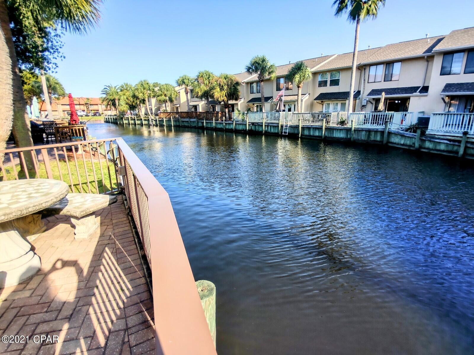 Grand ISLAND Unit ON THE CANAL & an END UNIT with an AWESOME PATIO overlooking the Canal. OUTDOOR LIVING is Great! New Flooring Upstairs & Downstairs, New Walk-in Tiled Shower, new Vanities, Gorgeous Fireplace. This 2 BR 2.5 Baths. Gulf Highlands Beach Resort is a GATED RESORT in the HEART of PCB and is in Walking Distance to several Attractions, Dining, Shopping, Post Office, and Walmart.  HOA fees are $700/Qtr and include Household Trash, Basic Cable, Internet, Lawn Mowing, Sprinklers, Some Pest Control, and the Amenities... 11 Pools ''5 Heated'', 4 Tennis Courts '' 2 Lighted'', Fitness Center, 18 Hole Mini Golf, 2 Playgrounds, Shuffleboard Courts, Conference Center, and a Private Club House with a Snack Bar on The Beach along with 1 of the 11 Pools.