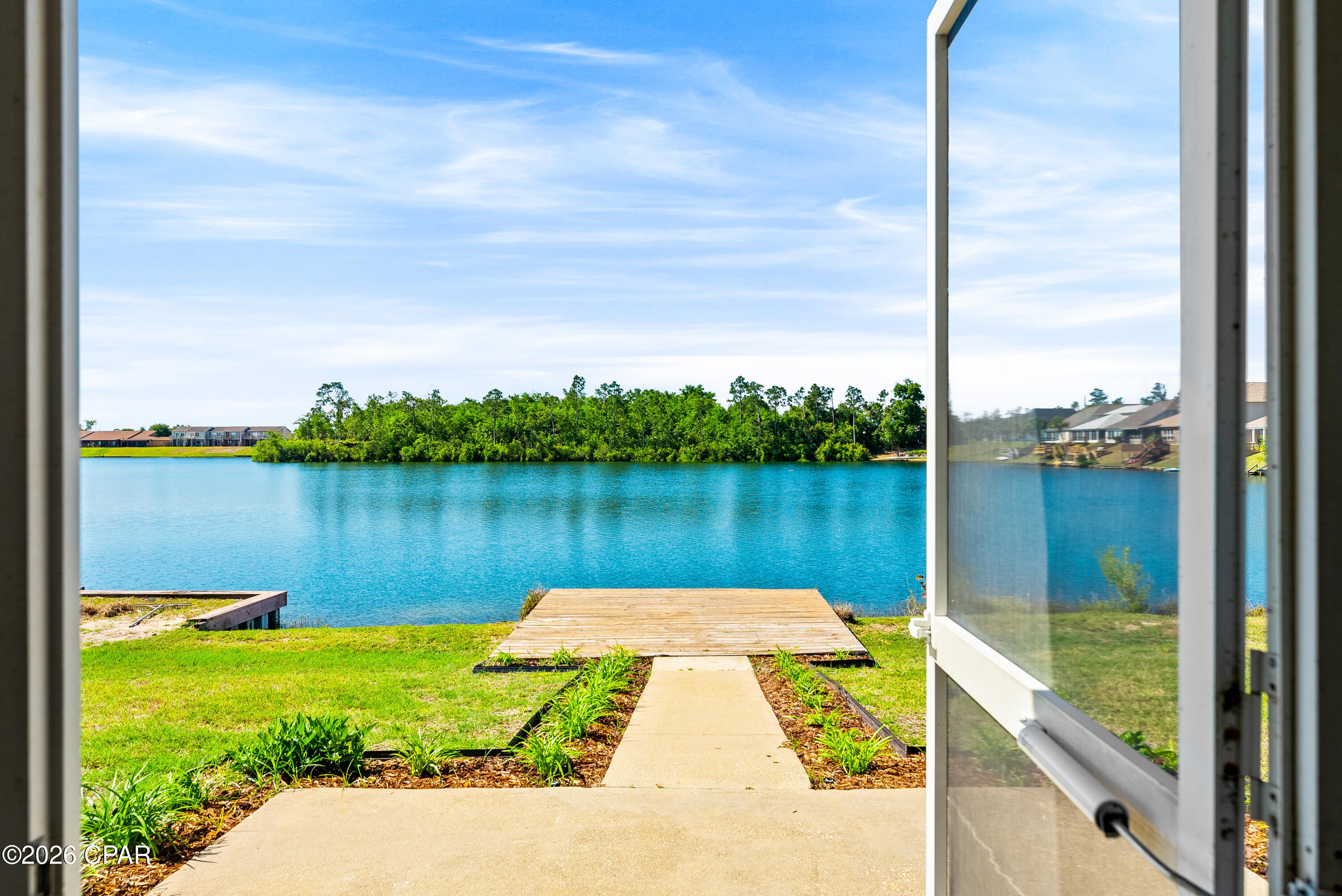 For lease - Waterfront 3-bedroom, 2 bath home overlooking Lake Marin in the heart of Panama City. Beautifully updated with vinyl plank flooring in the main living areas and bedrooms! Capture beautiful sunset views of the lake from the deck or screened porch. The home features an open floor plan great for entertaining. The updated kitchen features great cabinet and counter space, and stainless appliances, including refrigerator with ice maker, stove/oven, dishwasher, and vented microwave. There is a breakfast nook attached to the kitchen where the washer/dryer closet is also located. Connecting small patio for grilling convenient to kitchen. The spacious dining/living room has a tray ceiling and great natural lighting. The master bedroom is on the lake and has a tray ceiling, walk-in closet, ensuite bathroom with walk-in shower. Two additional bedrooms with Jack-and-Jill bathroom, tub/shower combination; Two car garage; *No pets allowed* INCLUDES Lawn Service and Irrigation water.
