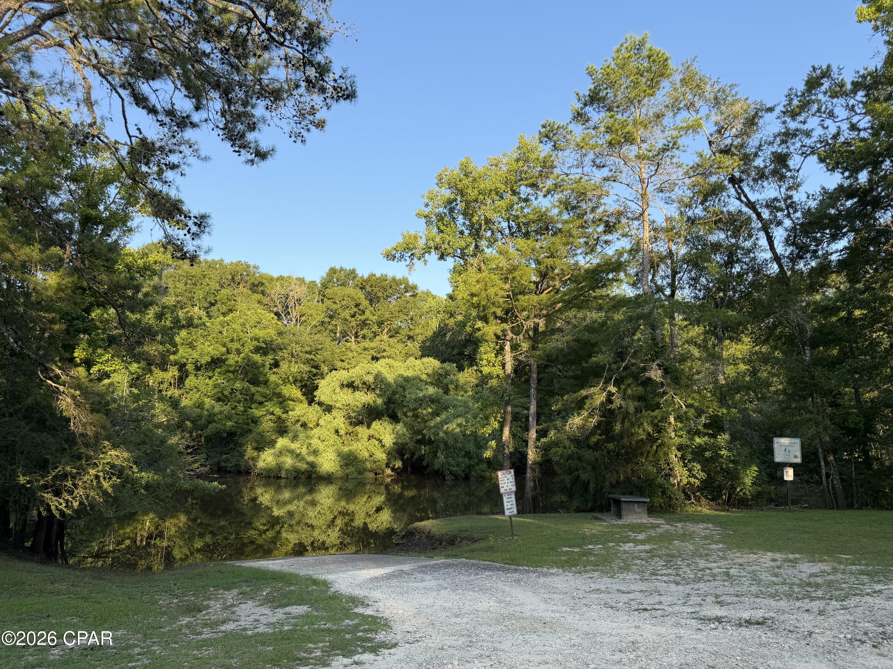 Have you been searching for the perfect waterfront getaway or future homesite? This beautiful 2-acre property, located just steps from Berrian Lake Landing in the Quail Hollow subdivision, offers scenic water views and easy access to the Choctawhatchee River, making it an ideal location for fishing, boating, and enjoying the outdoors.

The mostly fenced property includes two usable storage sheds, a covered carport, barn, and a pole barn with a lean-to that has been used to shelter an RV and features a handicap-accessible ramp. The RV conveys at no assigned value.

According to the seller, the property has two wells, two septic systems, and a separate electrical hookup at a cleared area of the property. Buyers should verify the condition and functionality of all improvements, as their condition is unknown.

Located in Flood Zone AE, this unique property offers endless possibilities for a weekend retreat, recreational property, or future homesite near the water. Per Walton County Zoning- zoned conservation which will allow one future home to be built or mobile home to be placed.  (Buyer to confirm with county what is allowed to be built and to necessary code standards.)

Don't miss this opportunity--schedule your private showing today!