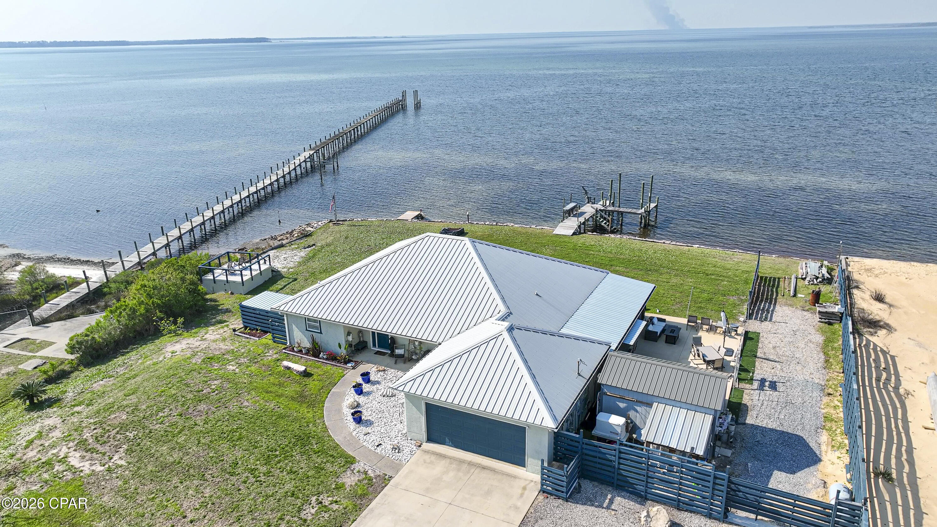 There is Waterfront and then there is WATERFRONT.  Welcome to 4018 PRINCESS LANE. End of the road privacy with over a half-acre lot with over 260' of Western wrap around never-ending beautiful sunsets and marine wildlife. Within 30' of the shorelines is everything from Dolphins, Manatees, Eagles, Ospreys and many other bird species. Being the end corner lot allows for one side of no adjoining neighbors. This beautiful but modest home sits in the middle of over half acre lot leaving a lot of space all around the property. The home sits on two lots and could eventually be divided if you choose. There is over 1,700 sq ft of waterfront views from every room. The home is a 2-bedroom 2 bath home with an additional home office with a waterfront view, too. This 10X10 room could be converted into a third bedroom if necessary. There is a beautiful Sunroom with new hurricane windows to sit and enjoy the bay. The improvements recently completed to the home are: New hurricane proof windows at a cost of $50,000.00, A 25-Kilowatt generator that will run the entire home for 2 to 3 weeks without power $12,000.00, An entire new rip rap wall seawall for additional storm protection $25,000.00, All new spray foamed insulation through entire home $7,500.00, An outdoor 30' x 40'  partially covered entertainment concreted area with room to lounge and enjoy the outdoors and soaking up the sun.  To include an outdoor kitchen and TV living room covered area- $20,000.00, the new dock was constructed in 2020, $15,000.00. The dock will handle up to a 25' to a 28'' boat easily in the summer. as the winter tides get shallow the depth drops. Dock could be extended if needed. There is DIRECT GULF ACCESS from the back yard. Privacy fence blocking the neighboring yard. The home is ready to move in!  Waterproof laminate flooring throughout the entire home. Widened driveway allowing for 4 car parking in the driveway plus adjoining gravel drive for 2+ additional cars. New 10'x16' storage building and an additional drive all the way into the back yard with a private area down to the water which has full hookup for an RV for your guest's privacy when they come to stay longer than you really choose for them to. Short term rentals are available in this area which would make for a great rental investment property and still allow all the private use you would care to enjoy. The home could easily sleep 8 to 10 people.  A small separate 12' x12' upper deck was built to enjoy the view over the small bayou area beside the home which has plenty of storage underneath for beach chairs, outdoor games, etc... Please pardon the YARD as we are currently working on beautifying it. Allow a 24-hour notice for appointments as the home is occupied however we may be able to accommodate on short notice. The owners are Licensed Realtors.