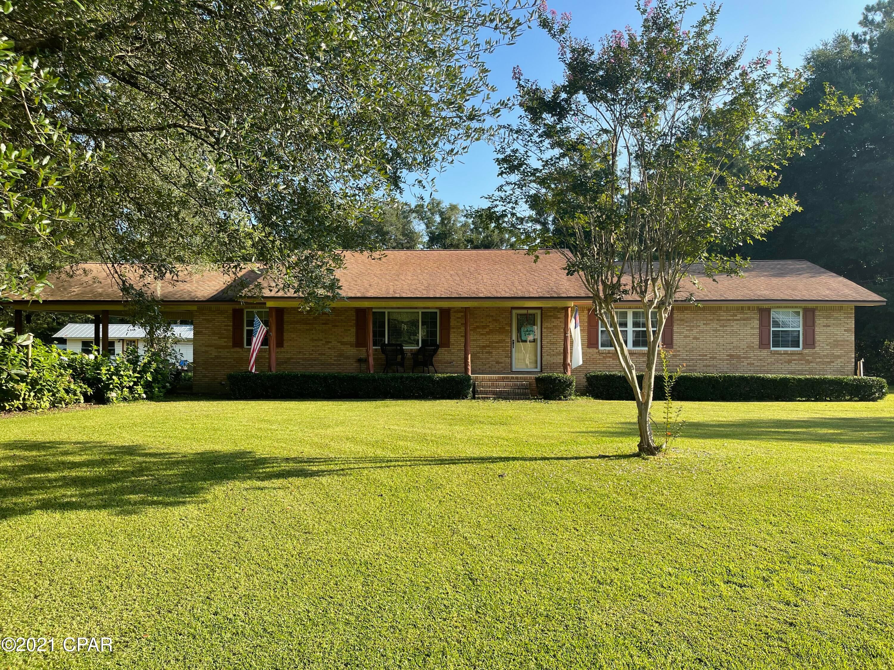 Beautiful 3 Bedroom 2 Bath house located within the city limits of Vernon FL. This home is shaded by large live oak trees and the oversized 1.37 acre lot consists of beautiful landscaped lawn and mature fruit trees. The house boasts a remodeled kitchen and bathroom with a large formal living area and den. The Master bedroom contains His and Hers walk-in closets. Large laundry room with plenty of place for storage. Very roomy detached building perfect for a workshop. This home also has a 2 car Carport and welcoming front porch. Make your appointment today to check out this stunning property.