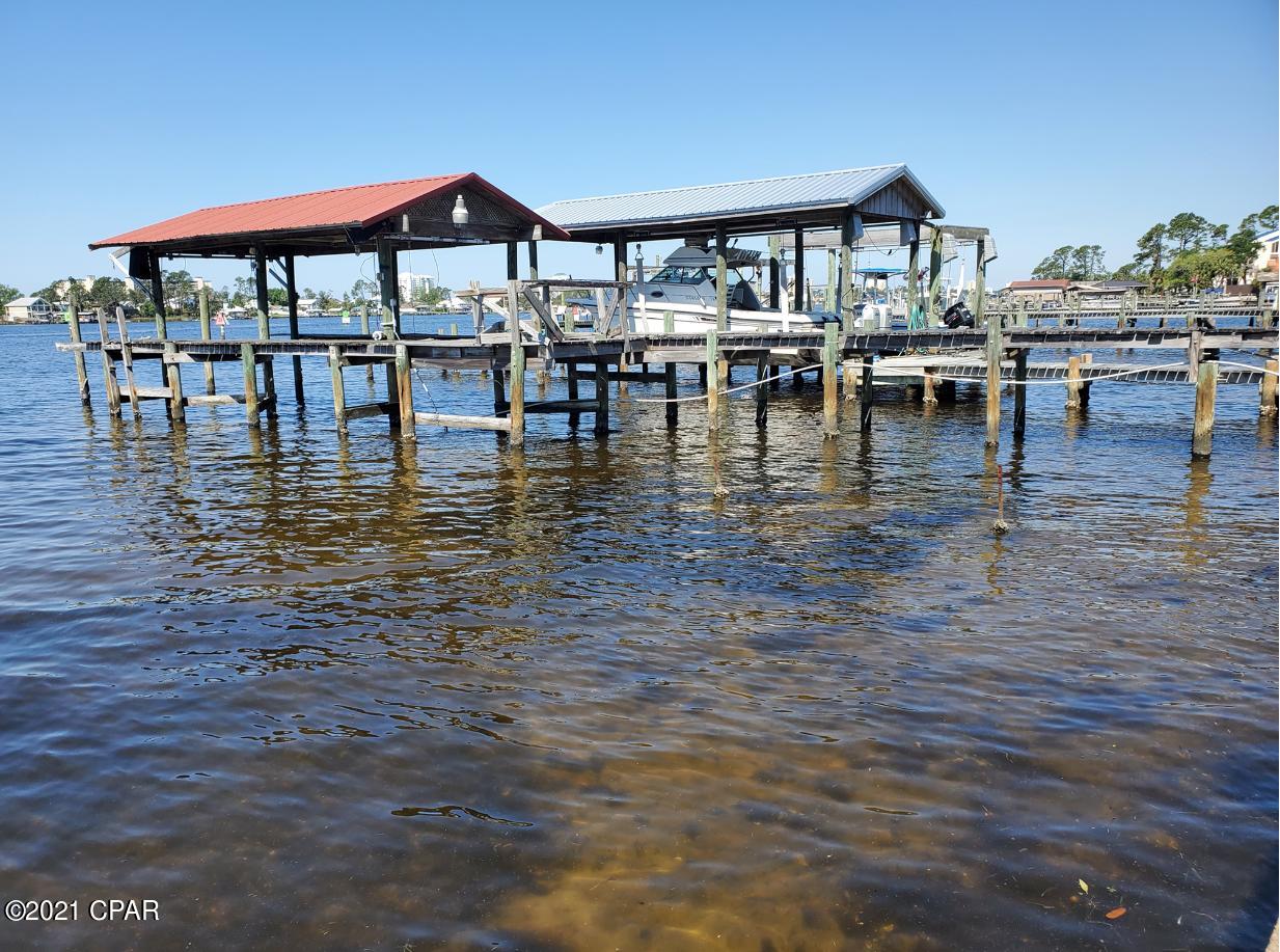 Location, location, location! Deep water access. Enjoy Beautiful sunsets across the lagoon. Property within walking distance to some of the best restaurants on the beach. Pilings for dock present. This home is being sold ''as is''. Great location to renovate existing home, or for building new home. Could be a great investment to build income producing duplex or triplex. All measurement are approximate. Verify if important.