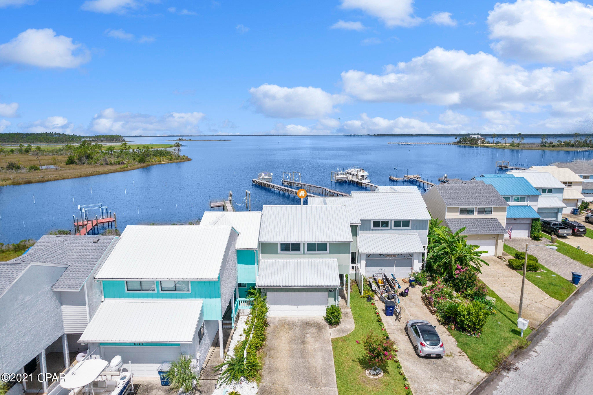 'CURRENTLY UNDER CONTRACT, SELLER ACCEPTING BACKUP OFFERS. Waterfront town home with the most beautiful sunsets you ever did see! This large home is conveniently located close to shopping, schools and is just 20 minutes to the beach. This home has a beautify remodeled kitchen with large soft close cabinets, quarts counter tops, large undermount double sink with an elegant backsplash In the Livingroom you will notice 2 large oversized 10-foot sliders that open up to the back deck and bay. This Livingroom view of the sunsets will stop you in your tracks. While you are on the back deck you will notice plenty of room for company when you entertain, places to grill and relax. In the living room you will also notice high ceilings, natural light from skylights and a corner fireplace with an elega wall and a one-of-a-kind mantle. Unlike most town homes this home features a 2-car garage for plenty of storage or parking. Right off the garage you will find a recently remodeled half bath with modern fixtures. Upstairs you will find 3 bedrooms, in the master you will have a view of the bay, a large walk-in closet and a bathroom vanity with plenty of room to accommodate both his and hers items. The other two bedrooms are good sized with large closet and storage space. Don't let this home pass you up.