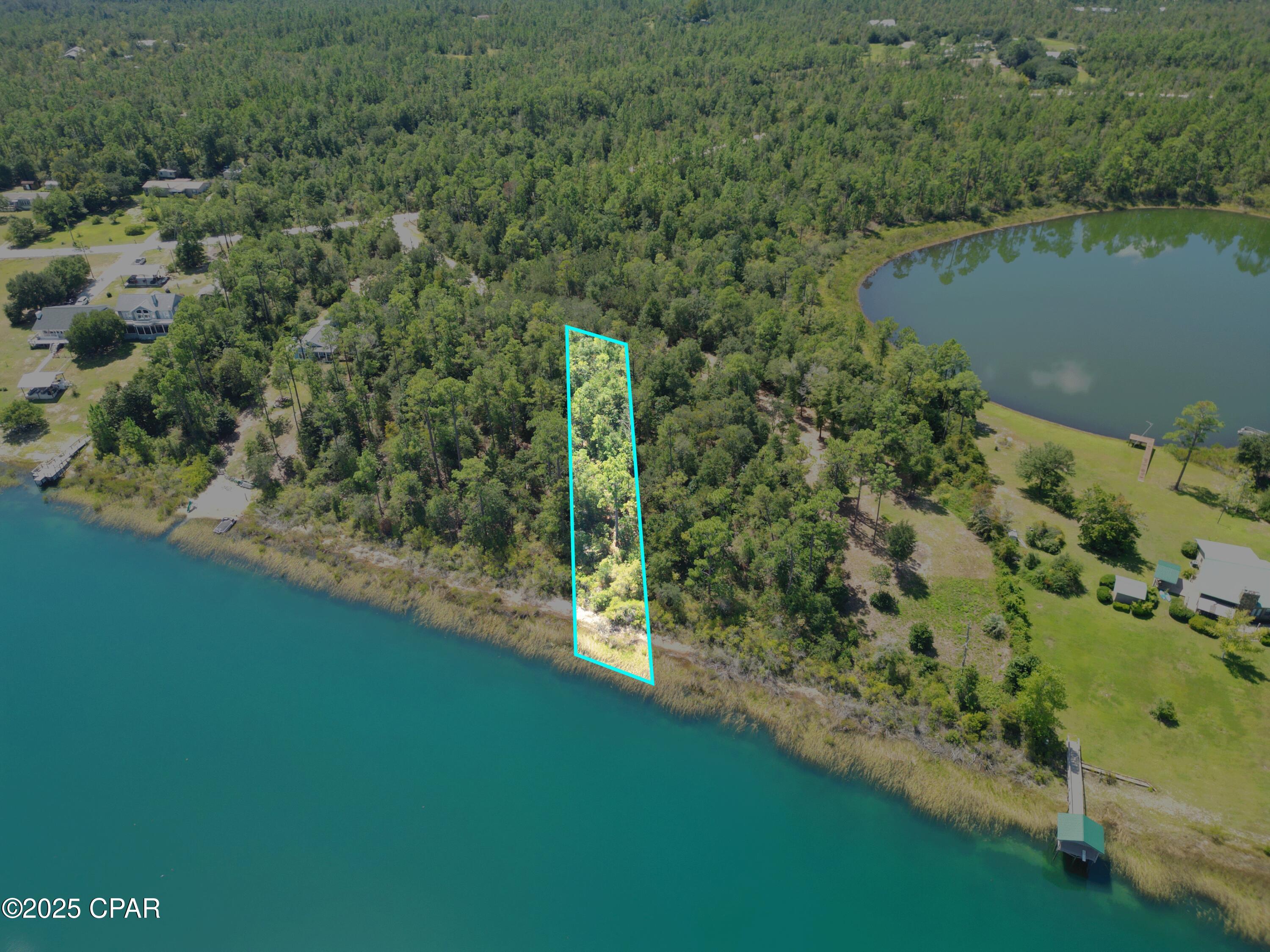 Discover the perfect waterfront retreat on Silver Lake, a hidden gem just south of Marianna and less than an hour's drive to the white sand beaches of Panama City. This parcel offers plenty of space to build your dream home, family compound, or weekend getaway.
Silver Lake is known for its sandy shoreline and crystal-clear fresh water, making it ideal for swimming, fishing, and endless recreation. To preserve its natural beauty, the lake prohibits gas-powered boats—keeping the water peaceful and pristine. Enjoy the quiet with electric motors, kayaks, paddle boards, and canoes gliding across the surface.
This listing is for one lot at $110,000 with approximately 80 feet of water frontage to be surveyed out. The owner has a total of 3 lots available - all 3 can be purchased for $310,000 or an individual lot only. Either way, you'll enjoy the best of lakefront living with easy access to Florida's Gulf Coast.