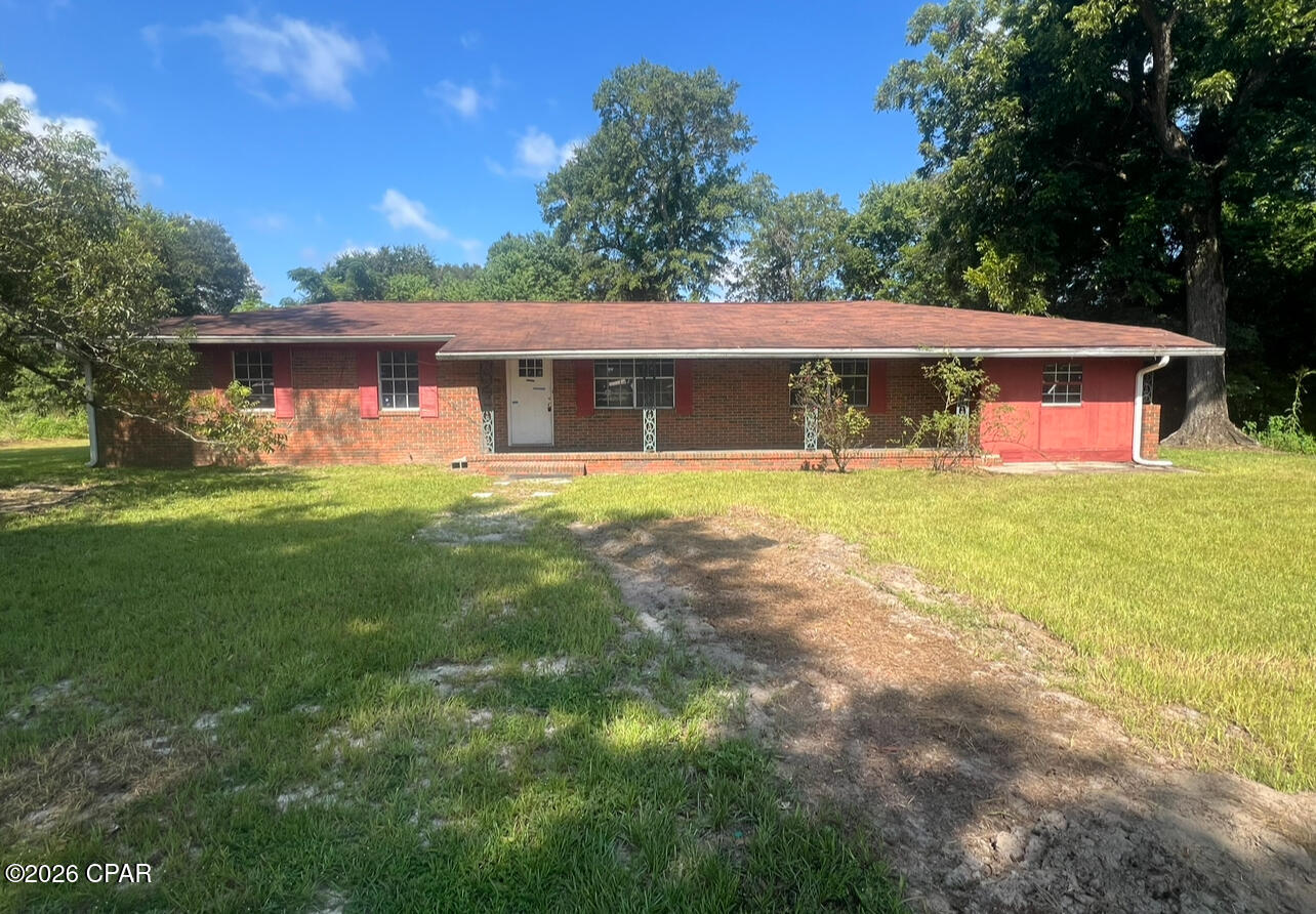 Large All-Brick Home on a spacious 1.64 acre lot in the City Limits!! This home has an open floorplan with a large family room. This could make for a great homestead, flip or long-term rental!  Home is solid but could use cosmetic upgrades, plenty of upside potential with this one. Power is on. City water. Nice outdoor workshop with covered parking. Priced to sell.