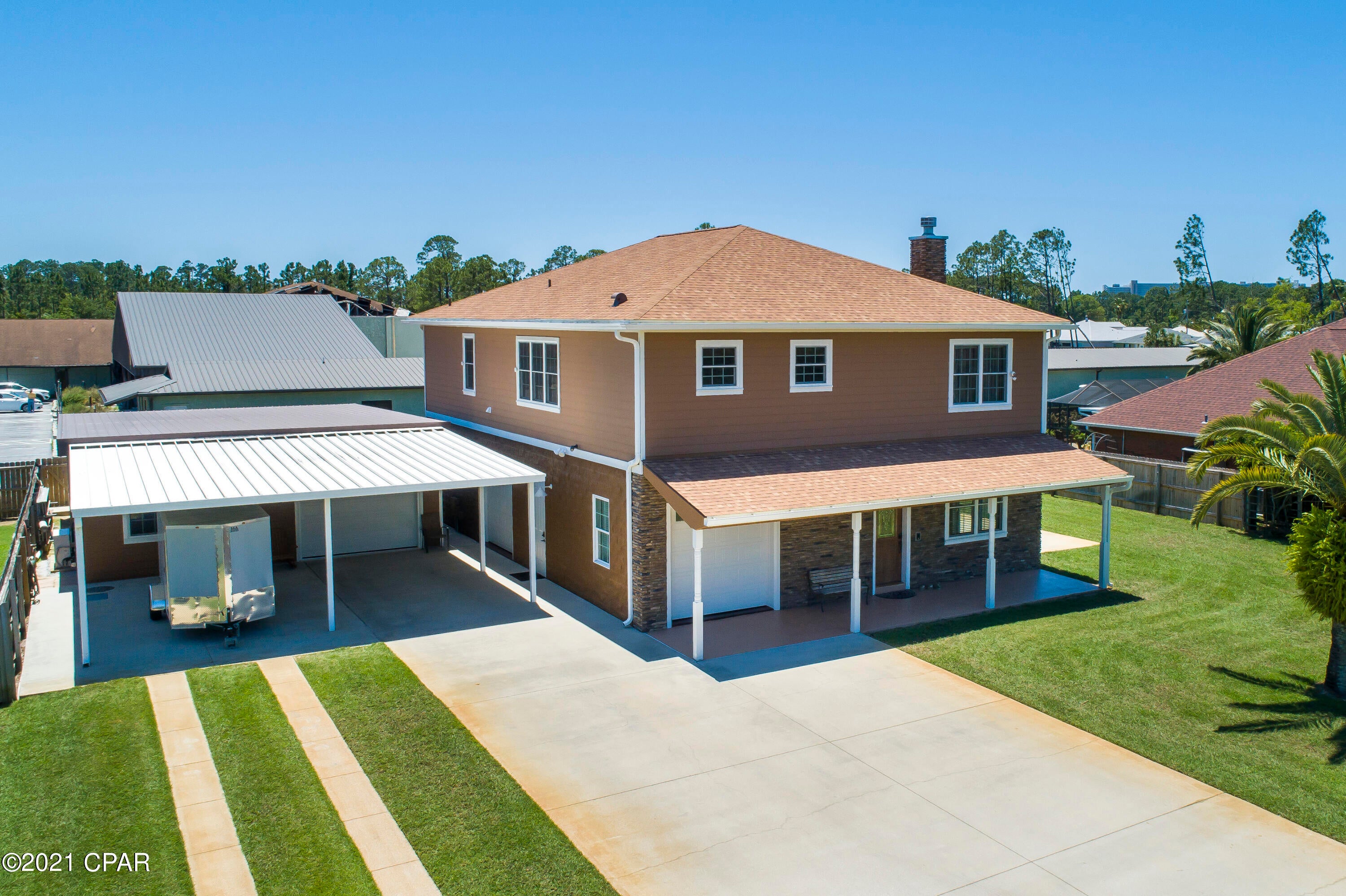UNDER CONTRACT WITH CONTINGENICES, SELLER ACCEPTING BACK UP OFFERS.

Custom-built 3 bedroom and 3.5 bathroom masterpiece located in the heart of Panama City Beach.  This executive home is impeccably maintained with custom finishes only found in the most exquisite residences in the nicest neighborhoods in Panama City Beach.

Custom features of this home include a trey ceiling in the living room, premium crown molding, custom 18-inch tile in the kitchen and bathrooms, custom kitchen cabinets, tiled bathroom showers, and hardwood floors in main living areas. The first level of this home contains a room that could serve as a living room or entertainment room.

This room has a massive ''movie-style'' projector screen that comes down discretely from the ceiling for the ultimate in entertaining. In addition to having a massive amount of room for entertaining on the first level, there is a full bathroom and IT room for servers, and computer hardware.
As you ascend the stairs to the second level, you will notice that the upstairs flows seamlessly from one room to another.
The living room is perfect for entertaining and open nicely into the kitchen with granite countertops, granite kitchen island, and stainless steel appliances including a new dishwasher.  The laundry room is located just off of the kitchen with newer washer and dryer (both washer and dryer convey with sale).  The master bedroom has two oversized his and hers closets, and an en-suite bathroom with his and hers sinks and all custom cabinetry.  
The two guest bedrooms share a hallway bathroom with tiled shower and tub.
The exterior of this home is immaculately maintained with new exterior paint, upgraded irrigation system, and recently pressure washed.  The front patio was just painted and the garage floors are painted.  The garage of this home is a dream with custom shelving and tons of space for golf carts, mowers, and lawn equipment.  The HVAC system is only 5 years old.  There is a  carbon filter on the water system that only needs to be replaced every 5 years.  There is a 1-ton heat pump for the office and a 2-ton heat pump in the main shop area.  The technology in this home is second to none with wiring for cameras and alarm system and pre-wiring for a pool.
The construction features of this home are astounding and here are some of the jaw dropping features:  main structure first floor has split faced concrete block with #5 rebar in every cell which is poured solid.  The second floor has 2x6 framing with Pro Bolt anchoring system, 5/8" rods every 4 feet and within 1 foot of every door.  5/8" plywood sheathing on 2nd floor exterior and roof deck.  Hardi-board siding on 2nd floor and detached building.
New 25-year roof rated for 150 mph wind with transferrable warranty.  Anderson windows.  Detached building is 2x6 framing with 5/8" Pro Bolt anchoring system with 3/4" plywood exterior walls and roof deck with metal roof.  Attached carport has 5 insulated garage doors (2 garage doors on the main house, and 3 garage doors on the detached building).  The detached building is set up as an office and shop.  
The shop can be converted to extra living space.
You have to see this home to understand the premium craftsmanship and construction.  Come see this home, and make it your very own!