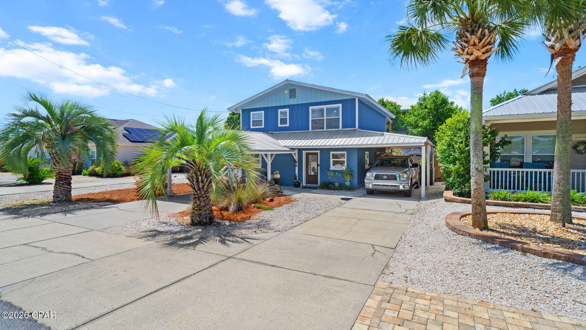 UNDER CONTRACT TAKING BACK UPS. RARE OPPORTUNITY with this Riviera Beach home just a few blocks from the Gulf!  Riviera Beach is a short term rental friendly neighborhood.  This 3BR/2BA home with a living room and kitchen on each floor.  The layout of the home is also unique in that there are two separate main entrances one downstairs and one upstairs. It would be easy to close off the second floor to live in & then rent out the entire first floor since short-term rentals are allowed or allow a wonderful inlaw suite.  The upstairs kitchen has  granite counters &  stainless steel appliances, & all of the flooring is Luxury Vinyl Plank.  The downstairs kitchen is complete with a eat in area. The large backyard is a gardeners dream with gorgeous plants, a fire pit and lots of entertaining space on the large upstairs deck. The downstairs patio is accessible from the home and allows another large entertainment space.   There is a carport over a portion of the large parking area with room for cars and a golf cart.  The roof, A/C and water heater are all newer, making this a sound investment.  Make your appointment today to see this beach beauty!