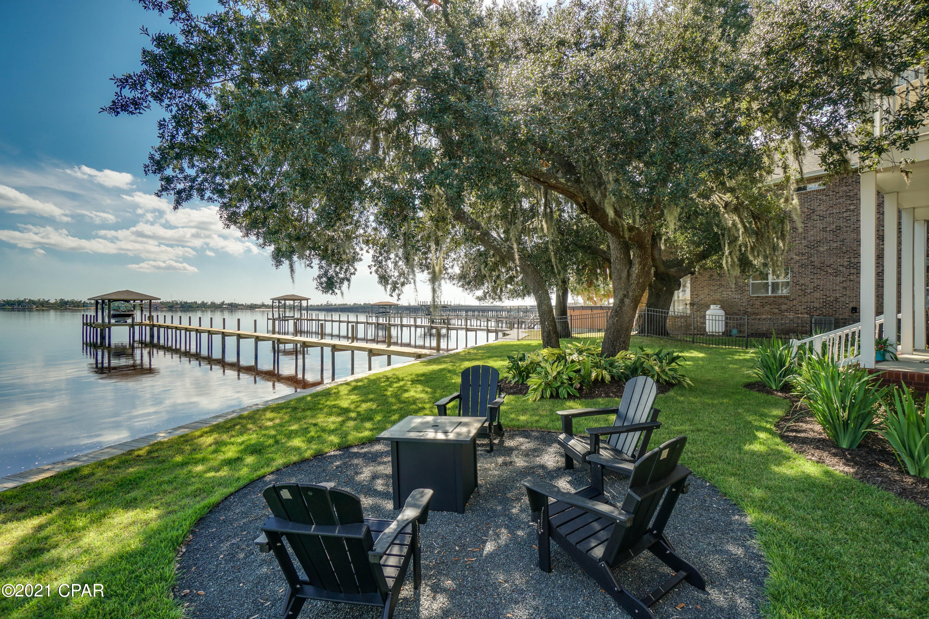 A Stunning Waterfront Property. The Interior is Beautifully Decorated and Has Great Finishes Through-Out. The Interior Is 4 Bedrooms and 3.5 Baths. Kitchen Is Finished Finely With All New Appliances and Quartz Countertops. New HVAC System 2019. Exterior Has a Brand New Roof 2019. Brand New Dock & 10K lbs Boat Lift & Seawall. Covered Boat House.  Waterfront Fire-pit. Backyard Is Fully Gated With 93Ft of Water-frontage. Currently Finishing a New Upstairs Outside Deck Area.