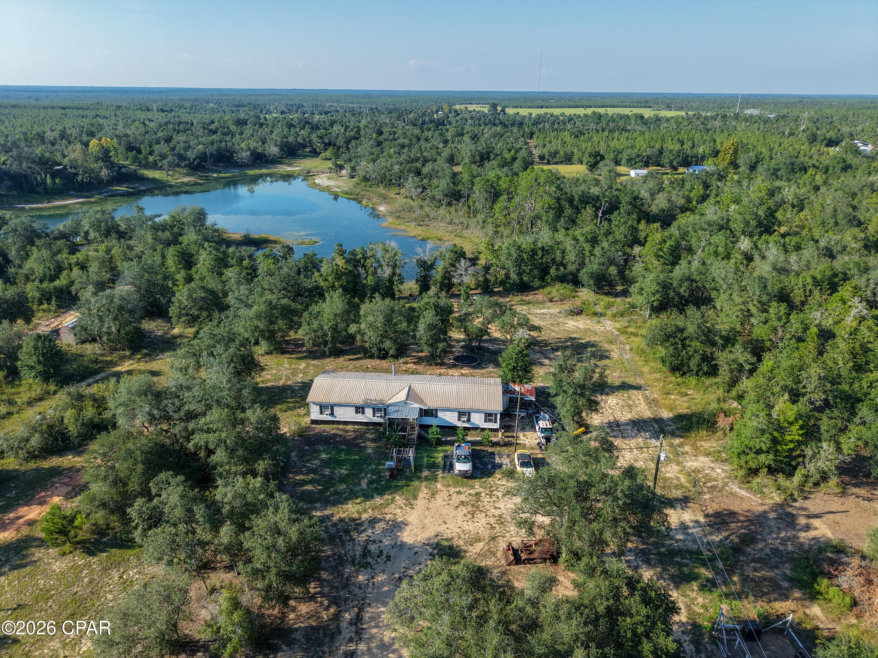 PRIVATE POND ACCESS! Enjoy peaceful country living with room to spread out! Situated on approximately 2.5 mostly cleared acres, this SPACIOUS family home offers private access to a large SPRING-FED POND, complete with its own boat ramp--perfect for fishing, kayaking, boating, or simply enjoying the water.

The property is PARTIALLY FENCED and already set up for animals, featuring TWO LARGE LIVESTOCK PENS ideal for cows, horses, goats, or other livestock. Water SPIGOTS are strategically placed throughout the property for added convenience, and an RV HOOKUP is already in place.

Inside, you'll find a spacious and inviting layout featuring TWO living areas, providing plenty of room for a large family, entertaining, or creating a separate den or game room. An ELECTRIC FIREPLACE adds a cozy touch, while NEWR FLOORING throughout gives the home a fresh, updated feel. OFFICE can easily convert to a 4TH BEDROOM if desired.

Located on a quiet dirt road and outside of a flood zone, this property offers the privacy and space you've been looking for without sacrificing convenience. You're still within approximately 10 minutes of Hwy 231, providing easy access to surrounding communities, shopping, schools, and amenities.

Bring the animals, the RV and the boat--this property has it all and is ready for you to come and relax and enjoy peaceful country living on the water.

**Photos in the listing have been digitally brightened**