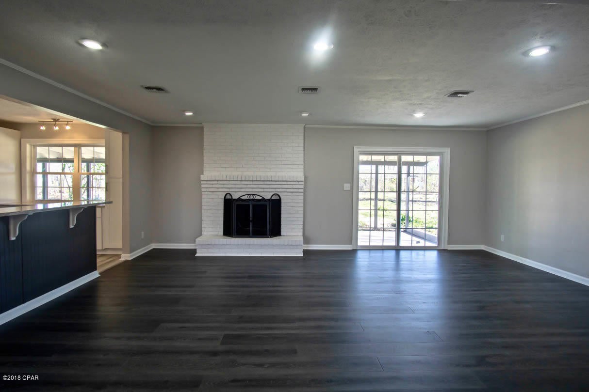 Absolutely Gorgeous Modern Remodel!!! 3/ 2 on 1.377 acres of land! 7 miles to Tyndall. All NEW roof, HVAC, windows, kitchen cabinets, granite counter tops, stainless appliances, water heater, flooring, vanities, etc, etc, etc!!! Even the garages are beautifully finished! Fireplace, huge laundry room, attached and detached garages, large covered back patio. No monthly water or sewage bill. And Location, Location, Location! Great neighborhood.