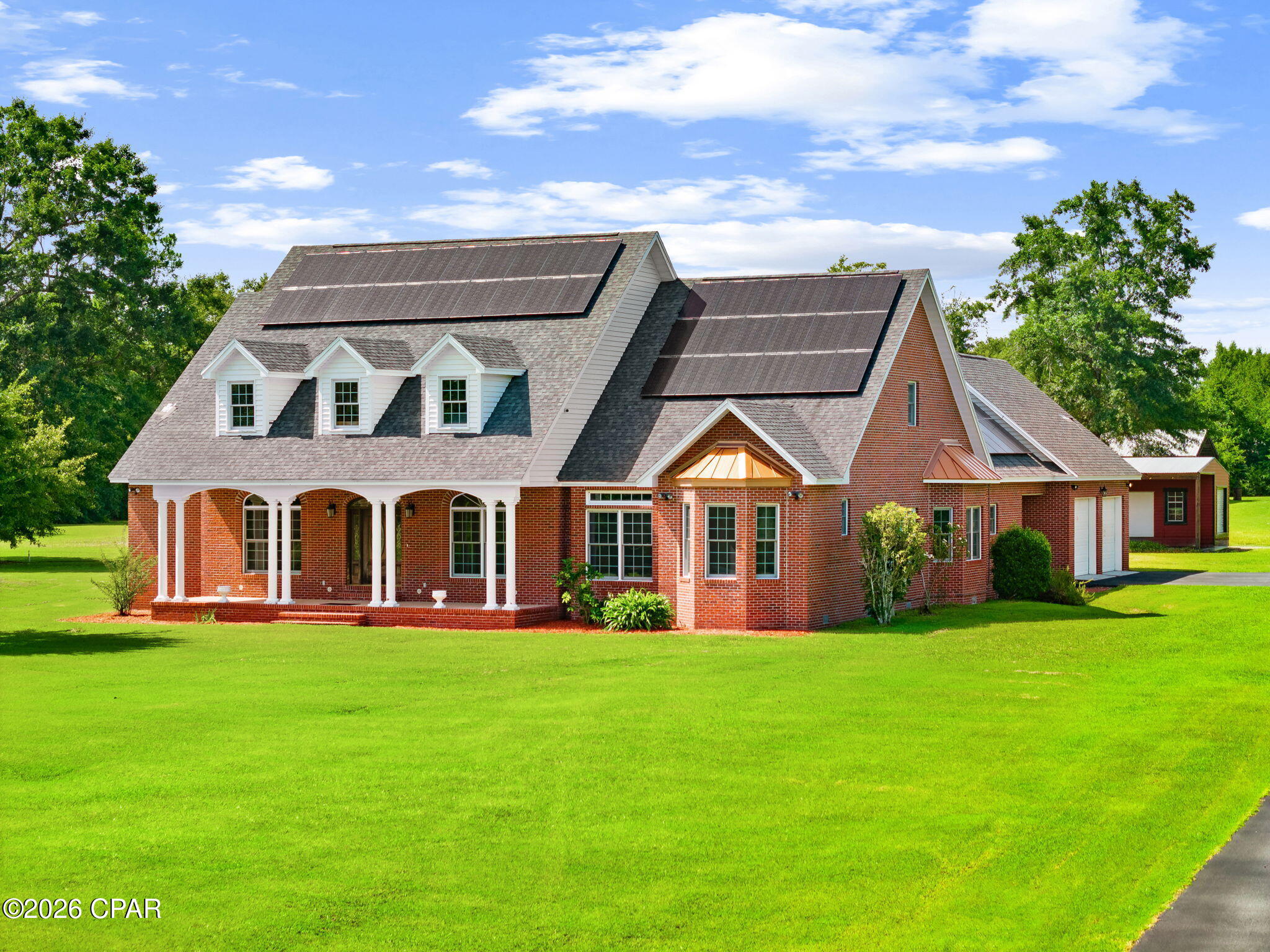 The coast is close. The quiet is yours.
Built like a storm shelter, finished like a custom home, and close to self-sufficient. 5,137 square feet on 5 private acres, reached by a long, paved driveway, a short drive from the beaches.
Built stronger than the code requires: twice the wall studs, a hurricane tie on
every roof truss. Owned solar: the monthly electric bill is just the FPL connection fee. Sole-source artesian well: cold, clear water from the ground, and even the outdoor spigots run cold and clear, with no water bill. 4 bedrooms and 4½ baths in slate, marble, hardwood, and custom tile. 12-foot ceilings, crown molding, hardwood through the living space, every closet cedar-lined. Steam shower, slate shower, clawfoot tub, jetted tub, wood-burning slate fireplace. Custom kitchen cabinets to the ceiling, dual-fuel range, upstairs wet bar and
entertaining space, screen-enclosed saltwater pool. Two garden plots ready to plant and a pole barn with a concrete floor Space, privacy, the coast, and near-zero utilities, together at one address. Built once, by hand, and you wont find another.