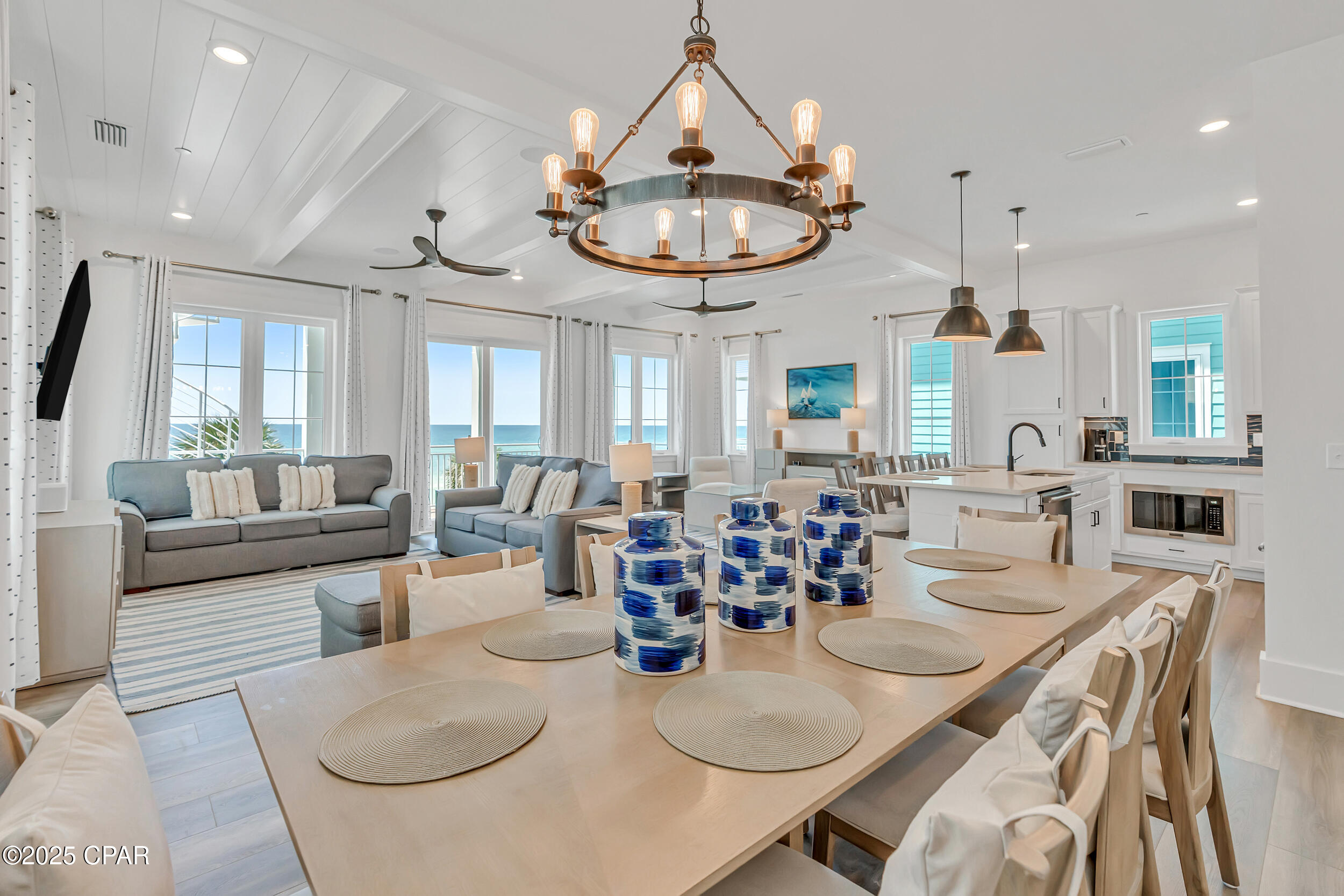 **PRIVATE ELEVATOR** This Gulf-front retreat in Margaritaville Beach Cottage Resort blends laid-back luxury with modern comfort, offering the ultimate escape in Panama City Beach. Built in 2023 and sold fully furnished, this Oasis floor plan spans 3,990 square feet across three levels - all with unobstructed views of the emerald Gulf waters. Professionally designed with decor that captures the breezy, carefree vibe of the Margaritaville lifestyle, the home features luxury vinyl plank flooring throughout and a thoughtful layout tailored for both relaxed getaways and high-performing rentals. From morning coffee to sunset cocktails, enjoy panoramic Gulf views from your private balconies on every level. The first floor features a spacious recreation room with a foosball table, wet bar, full-sized refrigerator, and ice maker - perfect for entertaining after a day in the sun. Step outside to your private 8x17 beachfront pool and take the private dune walkover straight to the sand. With 6 bedrooms, a bunk area, and 6.5 bathrooms, this home comfortably accommodates large families and rental guests alike. The private elevator makes each level easily accessible. On the second floor, an open-concept great room takes full advantage of the water views, with a living area, dining space, and a chef's kitchen featuring Frigidaire Professional appliances, a 36'' gas range, quartz countertops, and maple cabinetry. Two guest suites with private baths, a powder room, and a full laundry area round out this level. Upstairs, the Gulf-facing primary suite offers a true retreat with expansive views down the coast, a walk-in closet, balcony access, and a spa-inspired ensuite with double vanities and a walk-in shower. Two more guest bedrooms with private baths and a cozy bunk nook complete the third floor. Additional features include a two-car covered carport plus parking for three more vehicles - rare for Gulf-front homes. As part of the Margaritaville Beach Cottage Resort, you and your guests have access to top-tier amenities: a resort-style pool with a 425-foot lazy river and H2O Adventure waterslides, pickleball court, indoor arcade, game lawn, hammock grove, and poolside movie nights. On-site dining options include The Salty Rim Bar & Grill, Fins Restaurant & Bar, and Joe Merchant's Coffee & Provisions - perfect for everything from poolside snacks to sunset dinners. Whether you're looking for a luxurious vacation home or a high-performing rental property, this is a rare opportunity to own in one of the most exciting beachfront resorts on the Emerald Coast. Call today to schedule your private tour and explore rental income potential, projections, and how to make this island-inspired dream a reality.