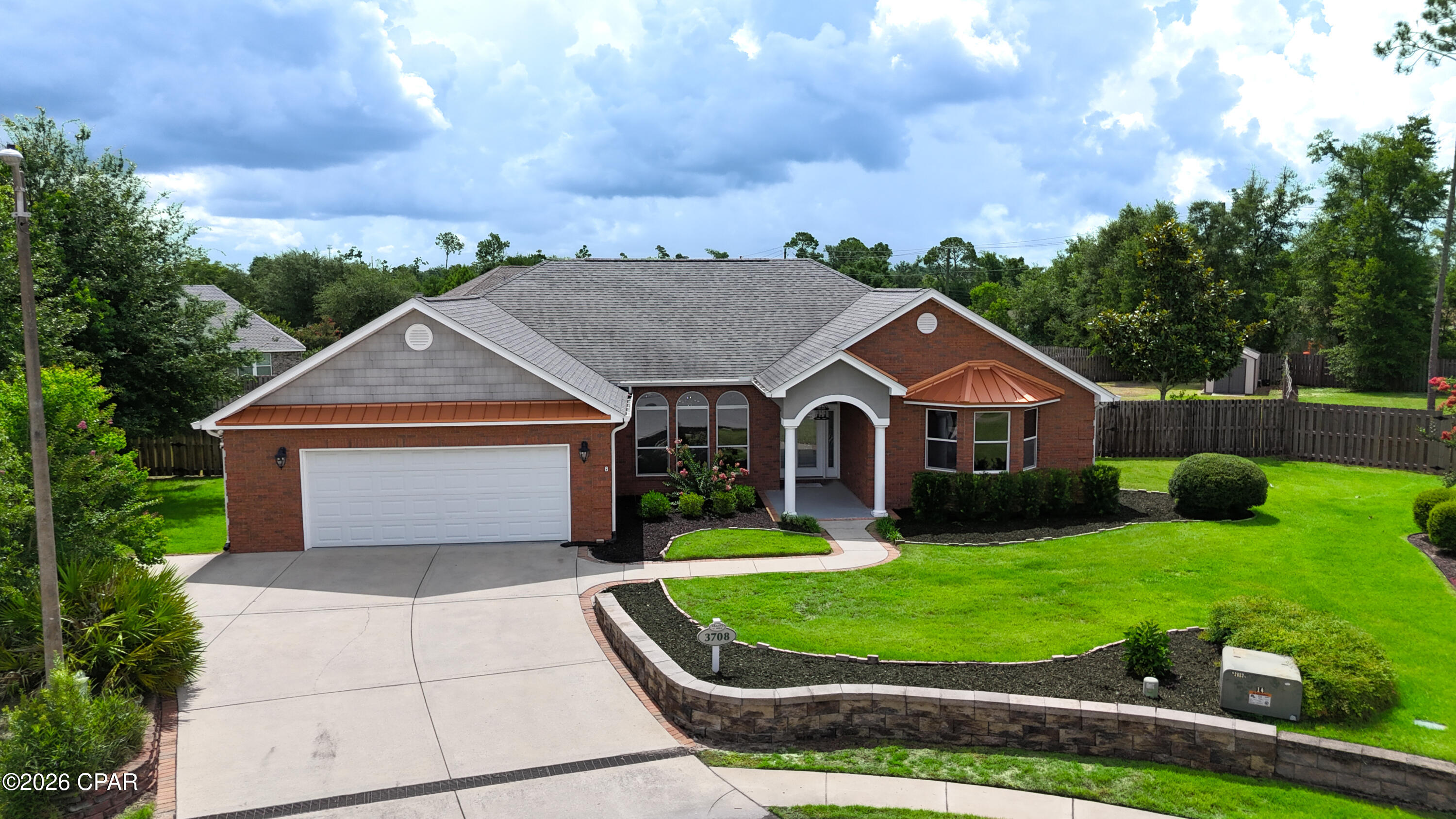 Welcome to this beautifully maintained custom home offering the perfect blend of quality craftsmanship, spacious living, and an outstanding location in the desirable Lynn Haven/Panama City area. Situated on a large cul-de-sac lot with convenient access to Highway 390, this 4-bedroom, 2.5-bath home offers the space, comfort, and flexibility today's buyers are looking for.

Step inside and you'll immediately appreciate the soaring 10-foot ceilings throughout, complemented by impressive 11-foot tray ceilings in both the dining room and the spacious primary suite. Crown molding, elegant architectural details, and an abundance of natural light create a warm and inviting atmosphere. The open-concept living area features an electric fireplace with remote control and flows seamlessly into the dining room, where oversized arched windows and a beautiful three-tier chandelier provide the perfect setting for entertaining.

The kitchen was beautifully updated in 2023 and is designed for both everyday living and entertaining. It features quartz countertops, abundant cabinetry with pull-out drawers and adjustable shelving, a pantry, touch-activated faucet, and a bright bay window breakfast area that fills the space with natural light.

The private primary suite offers an inviting retreat with its tray ceiling, oversized walk-in closet, and luxurious ensuite bathroom featuring a jetted soaking tub, oversized tiled walk-in shower with dual shower heads, and plenty of room to relax and unwind.

The additional bedrooms are generously sized with tall ceilings and walk-in closets, offering flexibility for family, guests, or a home office. One bedroom features a charming bay window that adds even more character and natural light.

Outdoor living is just as impressive. The oversized screened porch extends your living space and includes surround sound speakers, making it the perfect place to entertain, watch your favorite game, or simply enjoy the outdoors. The fully fenced backyard features an irrigation system, storage shed, and double gates that open toward Highway 390, providing easy access for a boat, trailer, or additional parking. With plenty of room to add a pool, detached garage, or workshop, the possibilities are endless.

Major updates provide peace of mind, including a new roof in 2019, as well as a new HVAC system and water heater installed in 2023. The attached two-car garage also includes an unfinished bonus room above, offering exceptional walkable attic storage or the opportunity to finish the space into a media room, home office, fitness room, guest suite, or additional flex space.

Conveniently located just minutes from Publix, restaurants, shopping, medical facilities, and North Bay Haven Charter Academy, this home offers both privacy and convenience while remaining close to everything Panama City and Lynn Haven have to offer.

If you've been searching for a spacious, move-in-ready home with modern updates, quality construction, oversized rooms, and endless possibilities, this exceptional property deserves a place at the top of your list. Schedule your private showing today and discover everything this beautiful home has to offer.