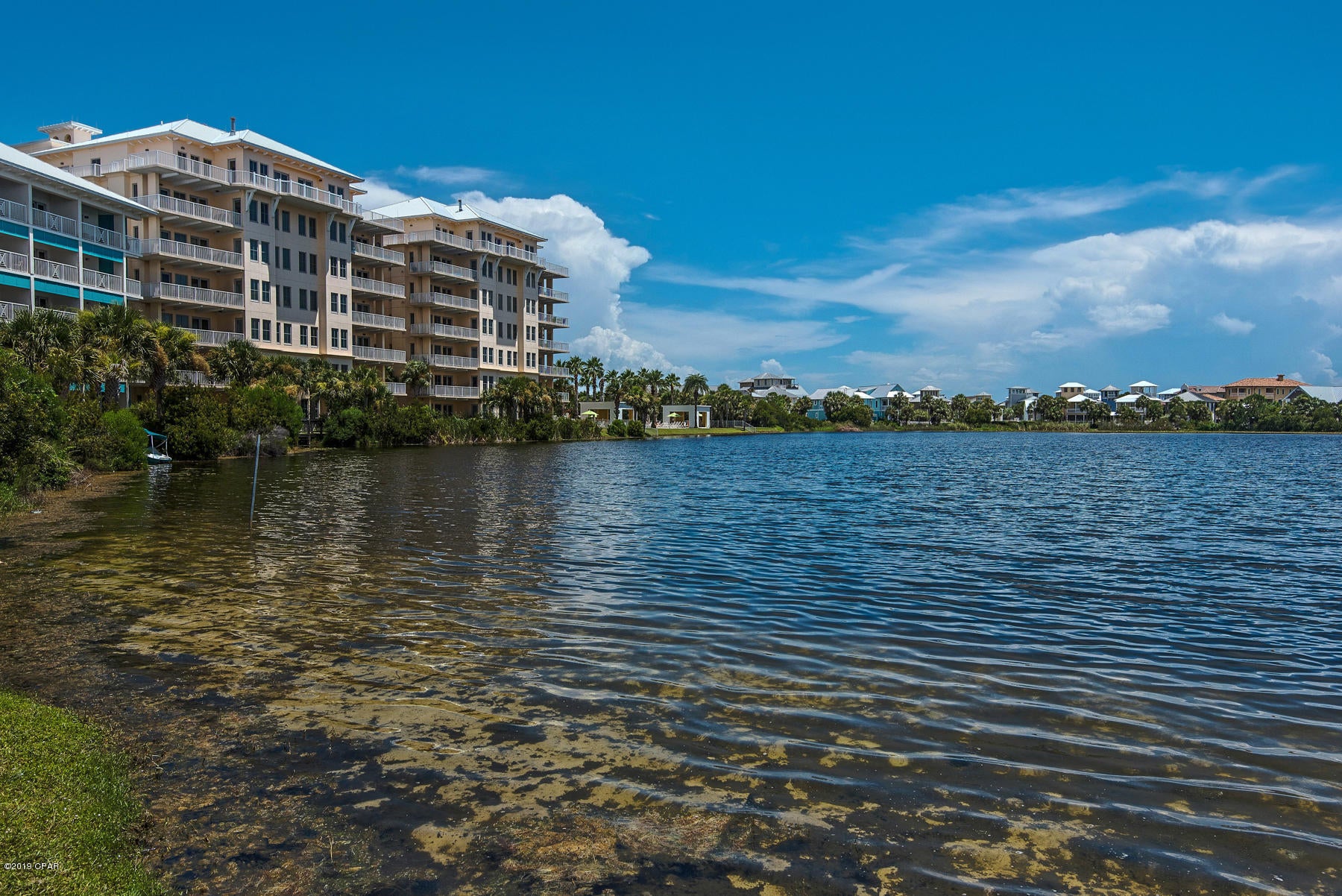 Gorgeous views of Lake Carillon but also of the Gulf of Mexico from this top floor unit in the Carillon Beach Inn. Decorated in a coastal  decor this unit has 2 bedrooms, 2 full baths, kitchen,living area, washer/dryer and two large balconies. This unit can be rented nightly, weekly,monthly or just a great getaway unit for your family. Carillon Beach offers a private beach, downtown center with restaurants, workout facility, Luxurious Spa, shopping and is also just a short distance from Pier Park. Carillon is a great destination spot for families with outdoor activities in mind. This unit generates roughly $26K per year in gross rental revenues through the onsite rental agency. Carillon Beach has several different Associations with HOA fees payable.