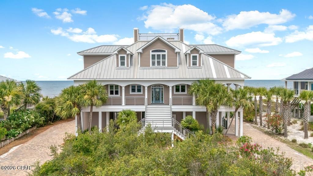 CURRENTLY UNDER CONTRACT, SELLER ACCEPTING BACKUP OFFERS. GULF-FRONT | 109 FEET OF BEACH FRONTAGE | PRIVATE POOL Experience the best of Cape San Blas from this custom-built Gulf-front retreat in Secluded Dunes community. Located just one home away from St. Joseph Peninsula State Park's 2,500 acres of protected land, this property offers unmatched privacy, breathtaking views & some of the most spectacular sunsets on Florida's Forgotten Coast. Designed to maximize its stunning waterfront setting, this 4BR/4.5BA home features a reverse floor plan with the primary suite & main living area conveniently located on the top level. Soaring ceilings, expansive windows, Brazilian cherry hardwood floors & an open-concept layout showcase panoramic Gulf views, while bay views can be enjoyed from multiple areas of the home. The gourmet kitchen is equipped with premium Viking appliances, granite countertops, custom cabinetry, double ovens & abundant prep space. A wet bar with wine cooler & beverage refrigerator makes entertaining effortless, while a 3-stop elevator provides convenient access to every level. Outdoor living is second to none with a large private Gulf-front pool, expansive wraparound decking, signature swing beds & a private boardwalk leading directly to the beach. Electronic screens on the primary deck & living area provide comfort while preserving the incredible views. Recent upgrades include brand-new Trex decking, while the brick paver driveway & beautifully landscaped grounds create exceptional curb appeal. Each bedroom offers direct deck access & stunning water views, providing guests with their own private connection to the coast. Additional features include fiber optic internet, public sewer, abundant outdoor living space & the rare combination of Gulf-front luxury with state park privacy. Located on the secluded north end of Cape San Blas, this property is ideal as a luxury residence, vacation home, or investment property.