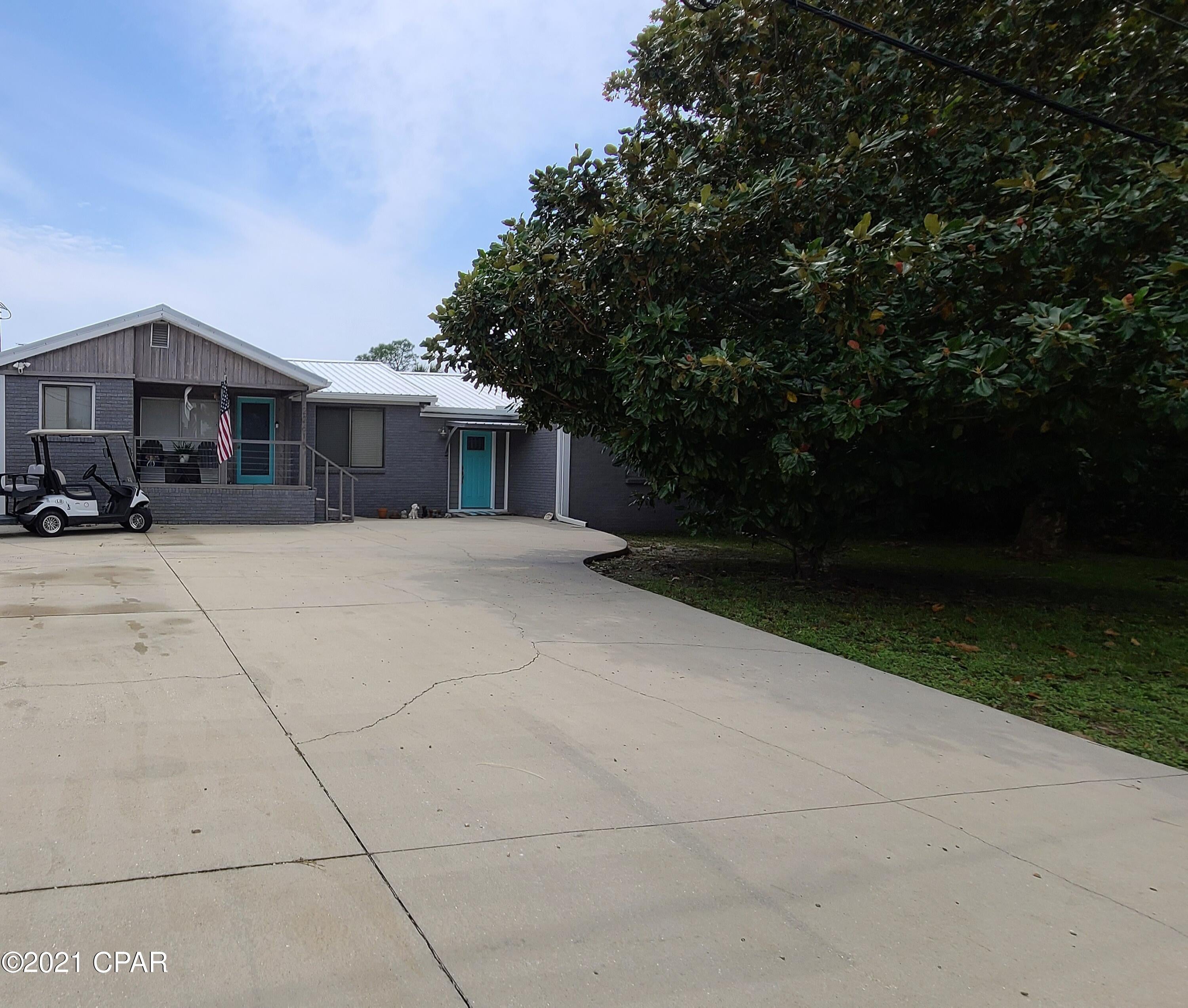 TWO LOTS and one Big House + Detached Office. Been dreaming of beach life on the West end of Panama City Beach? Now is your chance to buy a piece of paradise! Located South of Hwy 98, over 2300 SqFt H&C plus bonus exterior office space, on a double lot, and with No HOA fees! Ready for beach living but want room to park your toys without paying a fortune? This is it! Single story ranch home walking distance or short golf cart ride to the beach. Three bedrooms with walk-in closets, two bathrooms, and separate exterior finished office with power and AC (not included in Square footage). Split floor plan where one bedroom and bathroom could be an in-law suite, or a lock-out for rental purposes. Metal roof and gutters are less than 2 years old and this home is ready for a new owner!