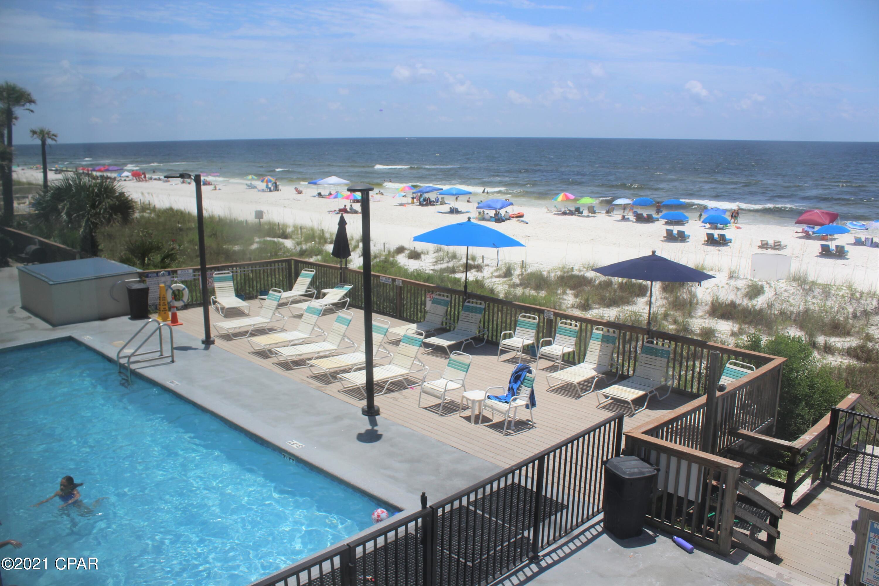 Beautiful gulf front unit with 2 bedrooms and 2 baths on the second floor of this low rise condominium. No waiting for an elevator, just one flight of stairs and you are there!  Bathrooms and kitchen are updated. Luxury vinyl plank flooring throughout. The living room and master bedroom have gulf views and access the balcony.  Whispering Seas is a 3 story complex with 30 units directly on the Gulf of Mexico.  Lots of beach space on the pretty white sand! Pool is gulf side with two grilling stations, a gazebo and picnic areas.  New outside HVAC unit in 2021.  Hot water heater replaced in 2018. Wonderful location on the east end of PCB.  Great rental history.  So if you are looking for a second home or investment property, this is it!  All sizes and dimensions are approimate and should be verified by the Buyer if important.